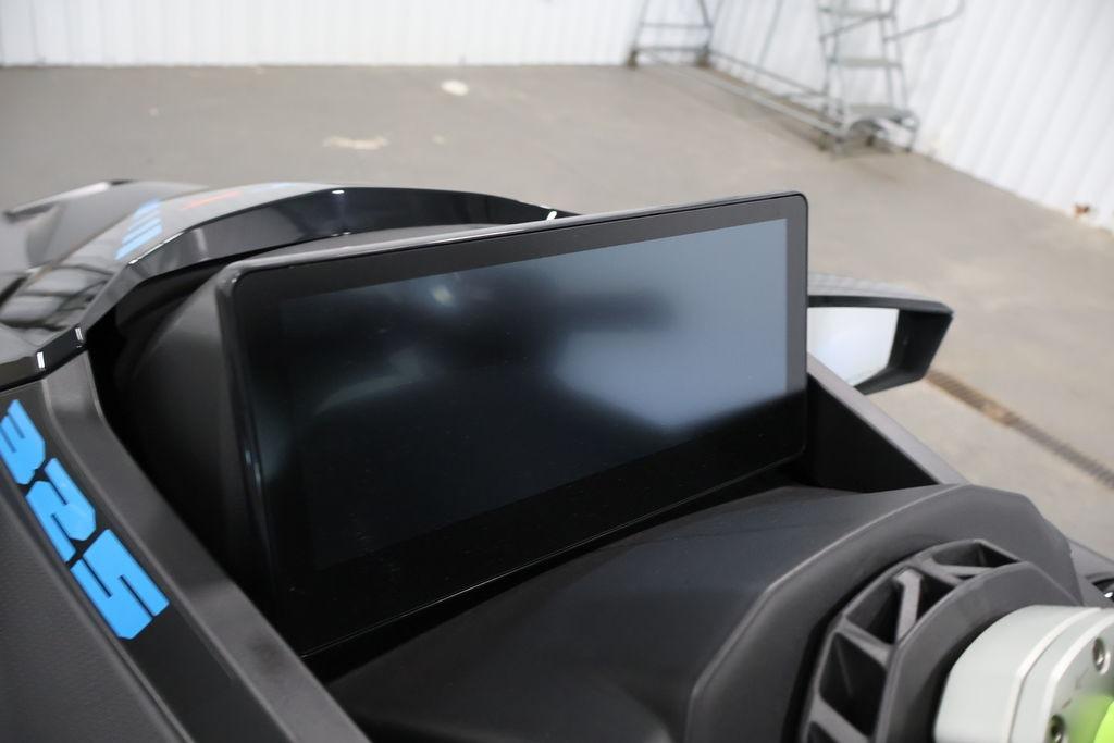 2026 Sea-Doo RXT-X 325 dashboard with digital display in a garage setting.