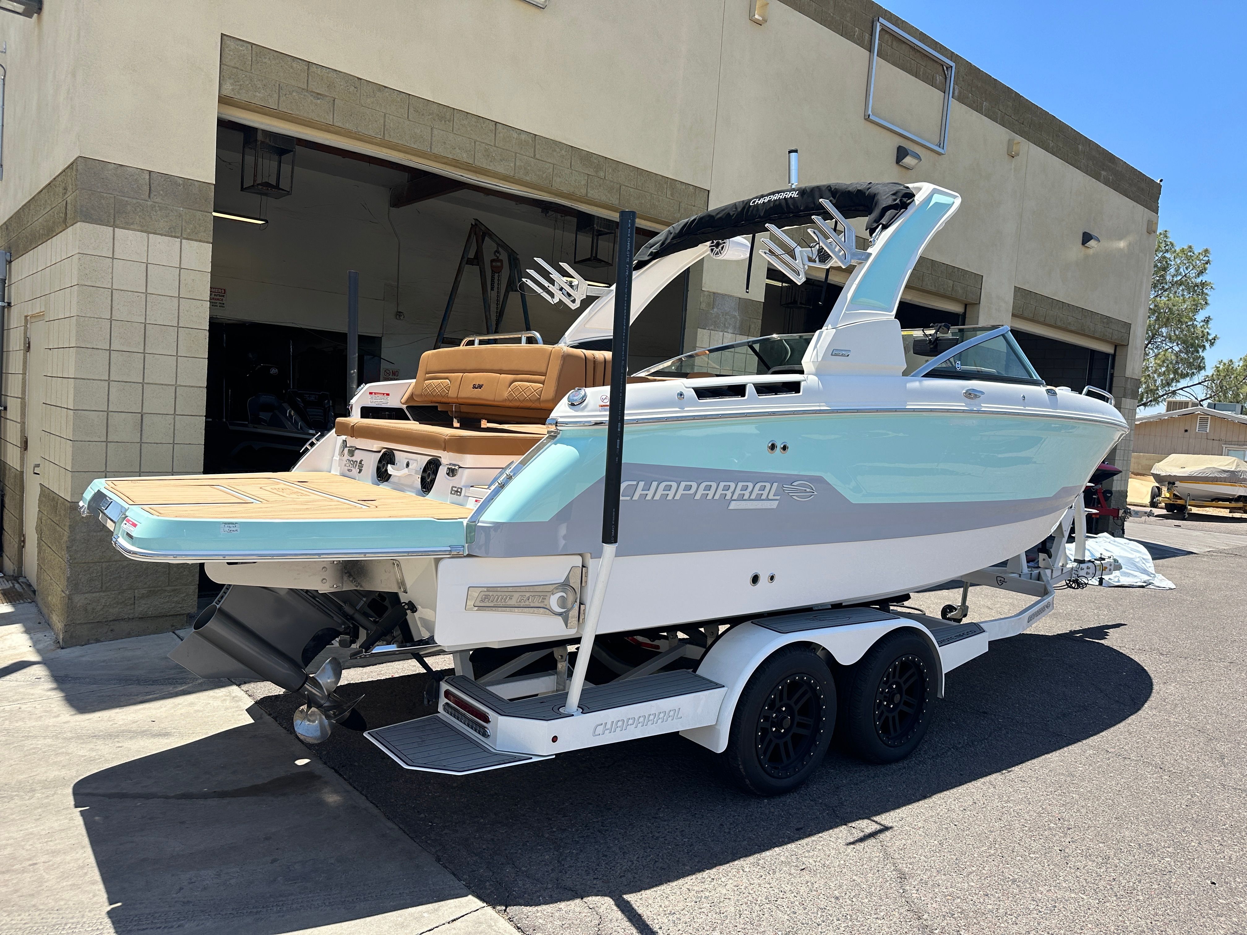 2025 Chaparral 26 Surf on a trailer outside a garage.