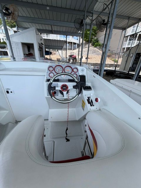 The image shows the cockpit of a 2002 Baja 25 Outlaw with a sporty steering wheel.