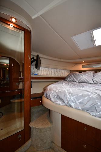 Luxurious cabin interior of 2003 Sea Ray 460 Sundancer yacht with cozy bedding.