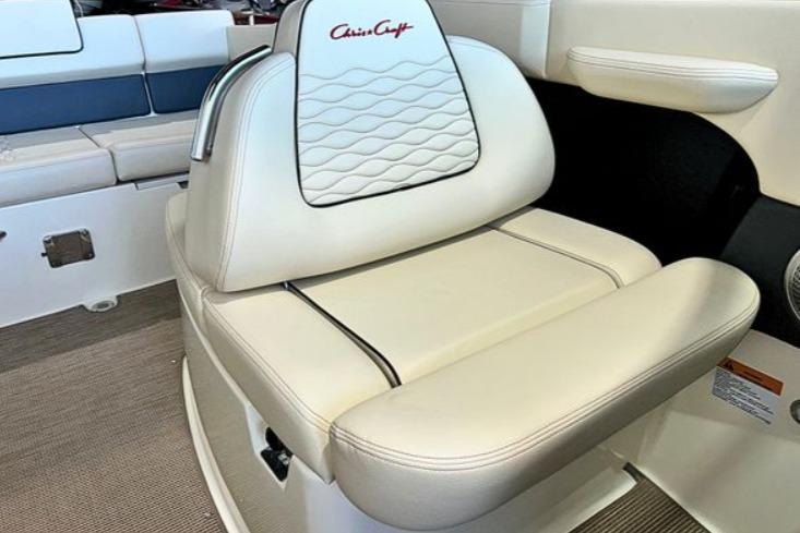 2025 Chris-Craft Sportster 25 boat seat with elegant white upholstery and logo detailing.
