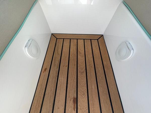 2025 Mag Bay 43 Center Console teak deck with built-in speakers.