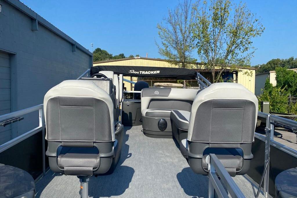 2026 Sun Tracker Bass Buggy 18 DLX pontoon boat interior with seating and canopy.