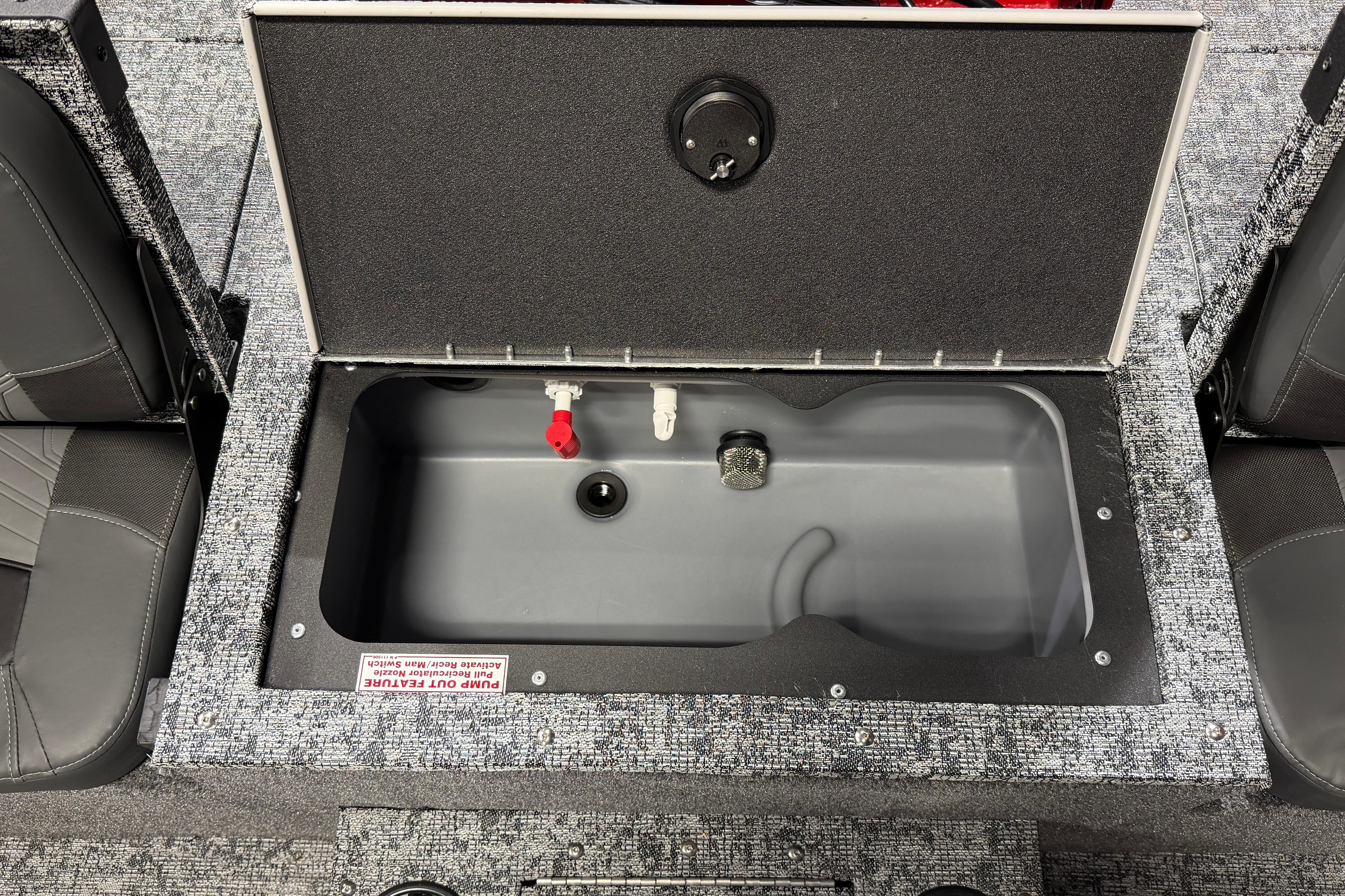 2026 Tracker Targa V-18 Combo boat storage compartment with open lid and seating.