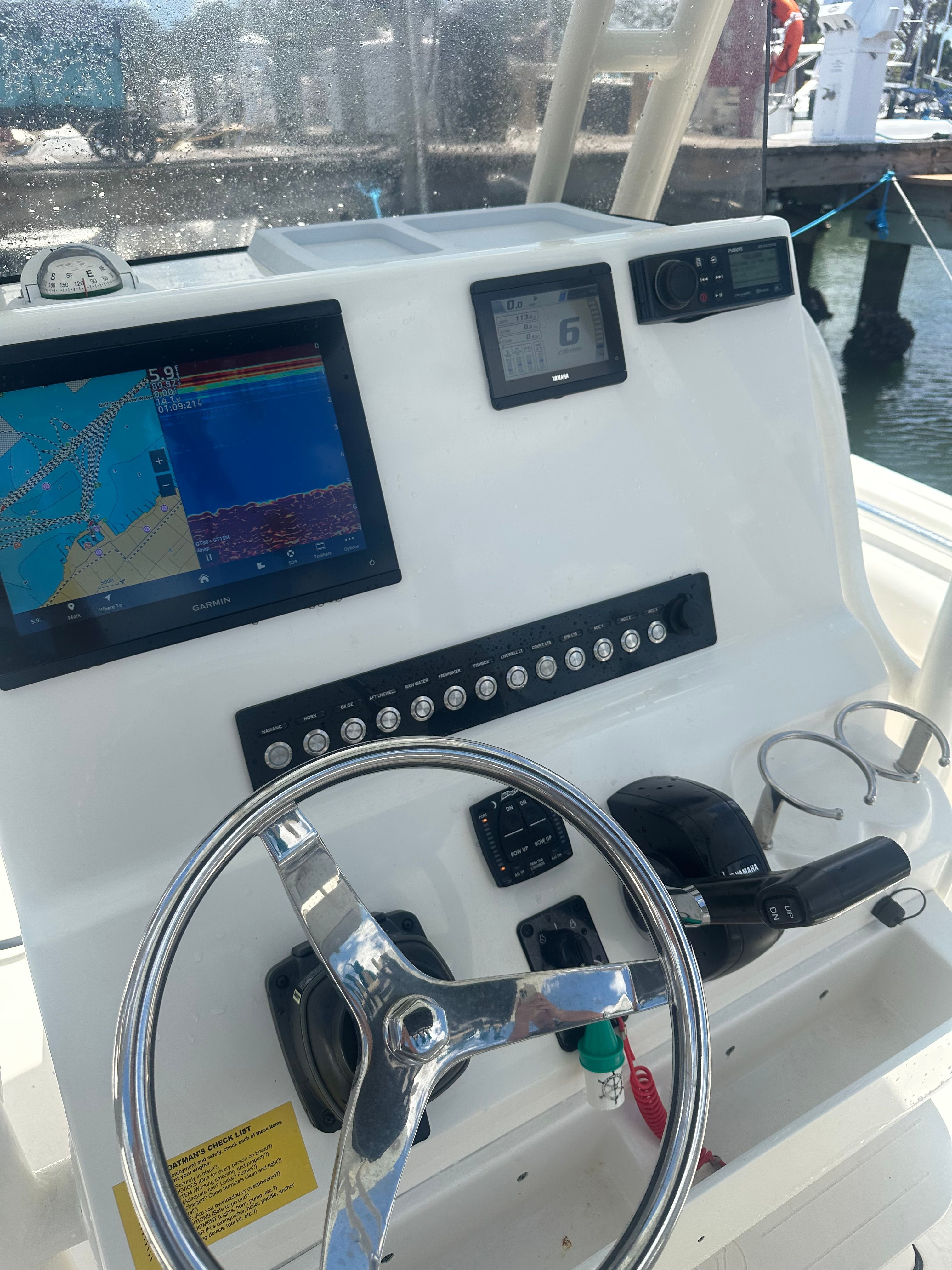 The dashboard of a Key West 219 FS boat with navigation screen and controls.
