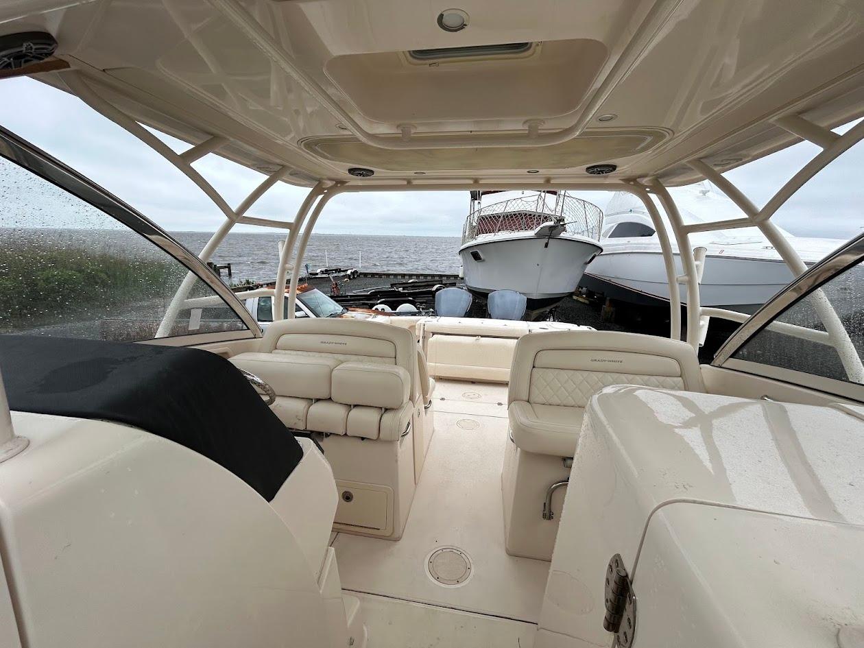 2019 Grady-White Freedom 325 boat interior with seating, docked near other vessels.