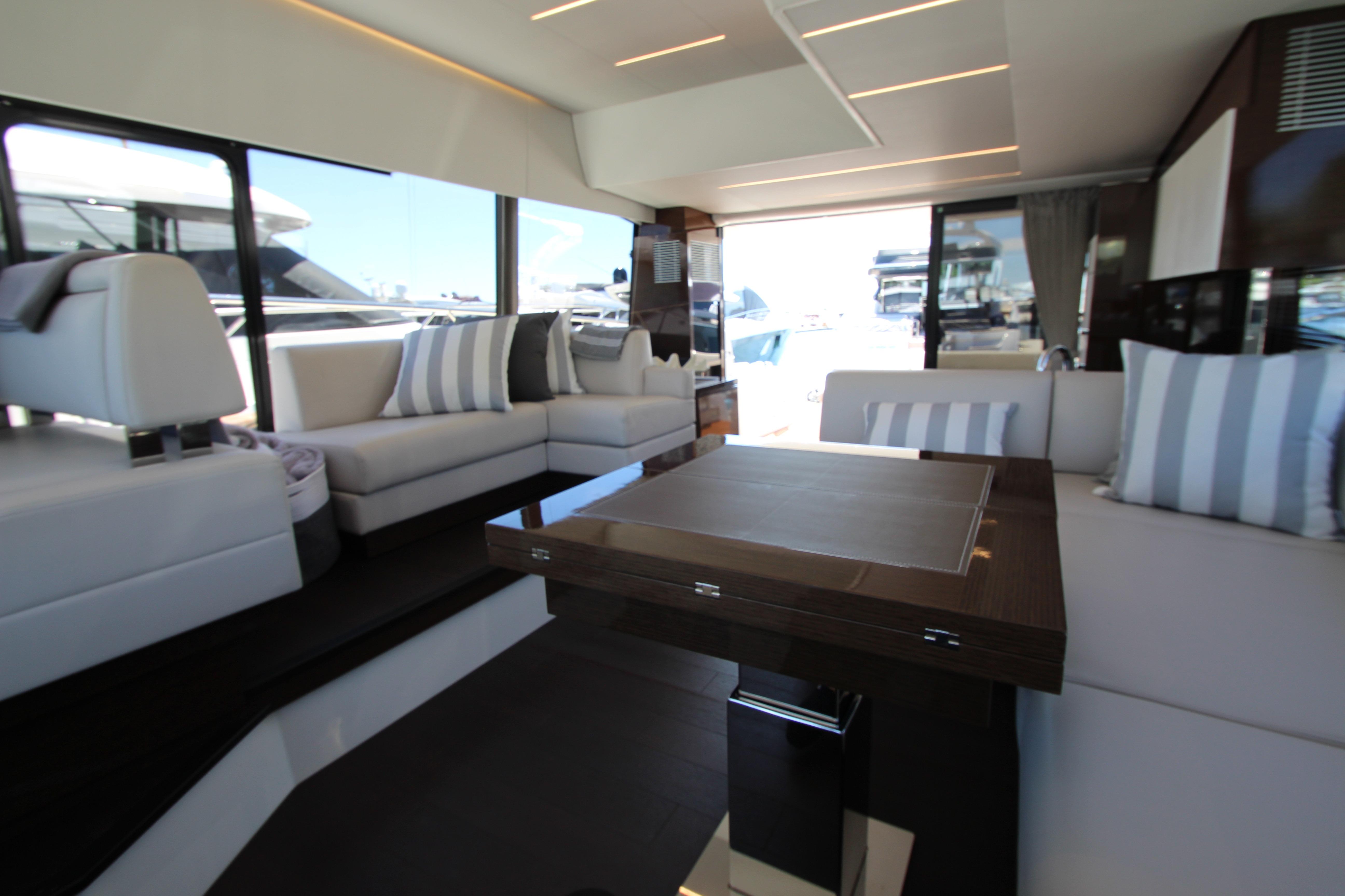 Luxurious interior of a 2022 Prestige 520 yacht with elegant seating and modern design.