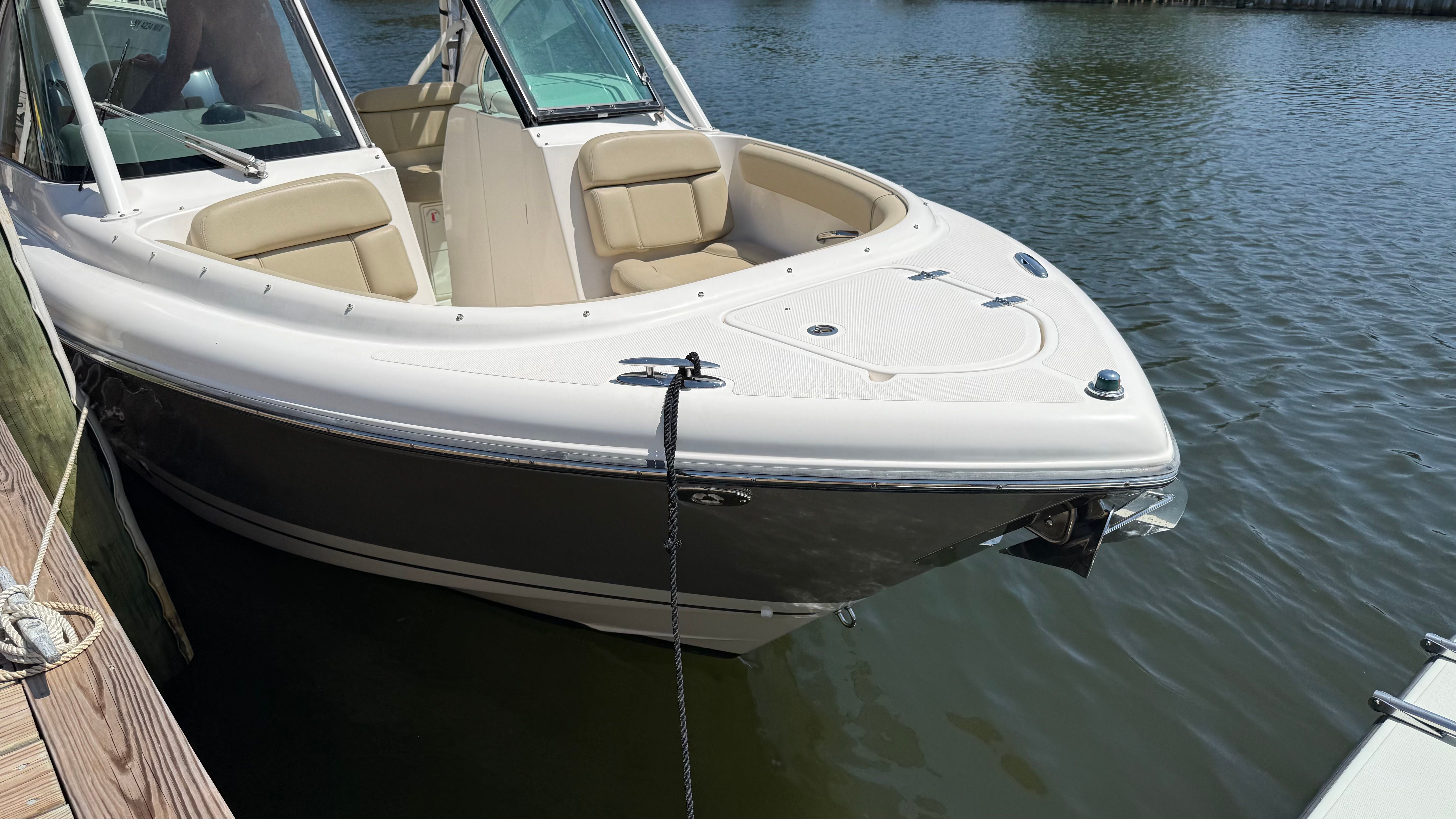 A 2016 Pursuit DC 265 Dual Console boat docked on the water.