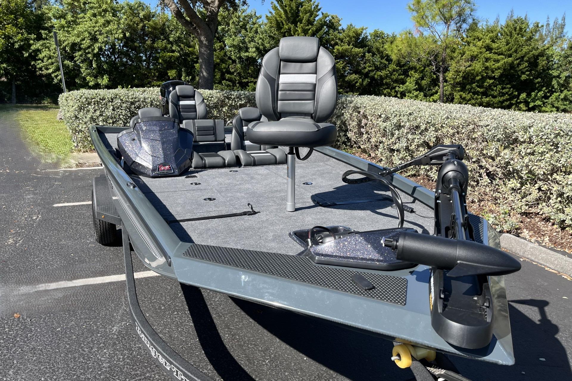 2026 Ranger RT188P fishing boat with seating and trolling motor in a parking lot.