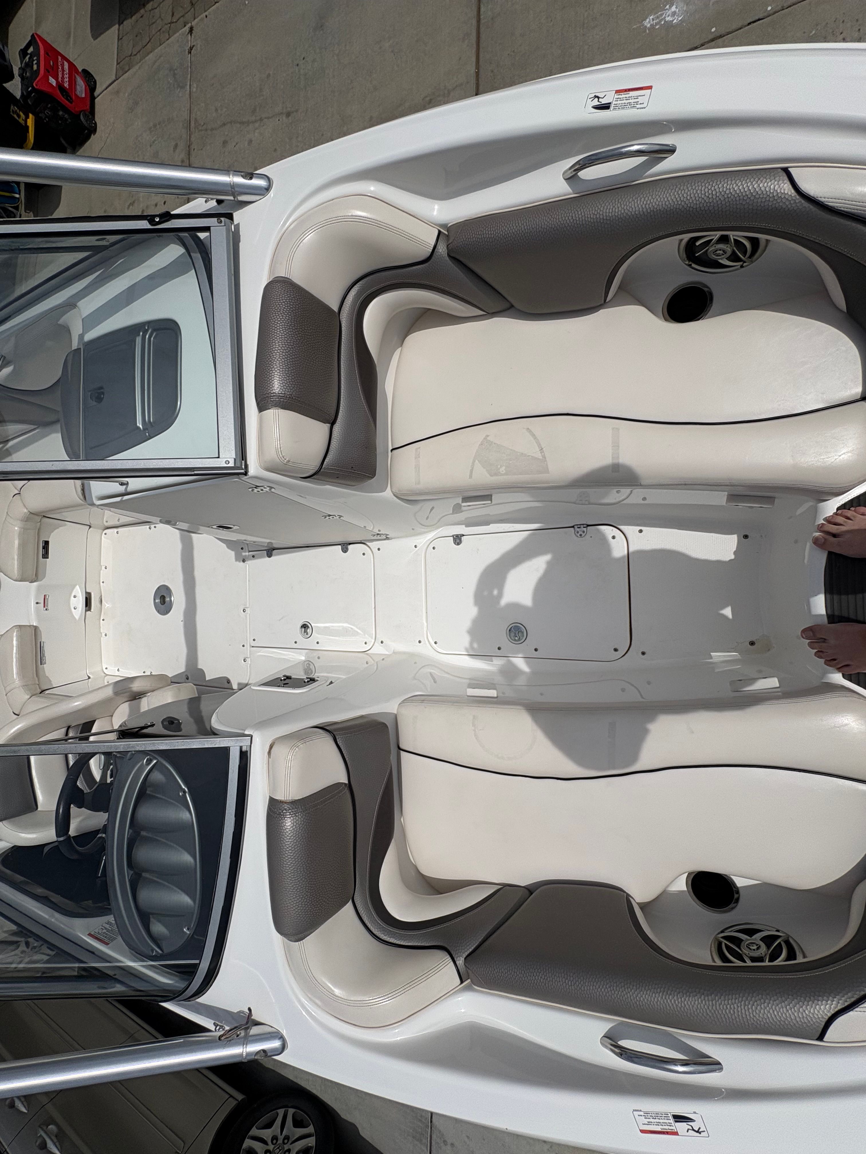 Interior of a 2009 Yamaha Boats 212X with white seating.