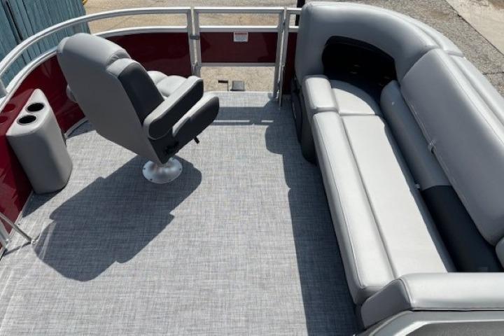 2026 Sun Tracker SportFish 20 DLX pontoon boat interior with seating and captain's chair.