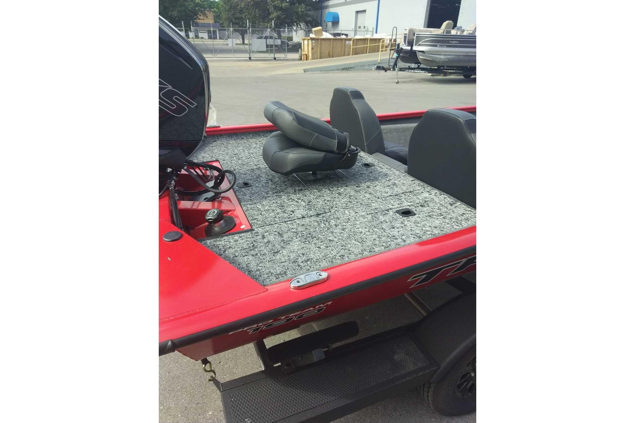 2026 Tracker Pro Team 190 boat with red exterior and gray interior seating.
