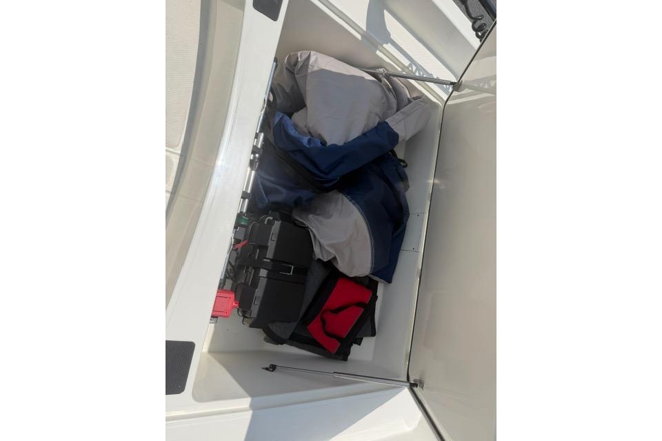 Storage compartment of 2025 Mako Pro Skiff 17 CC with gear and equipment.
