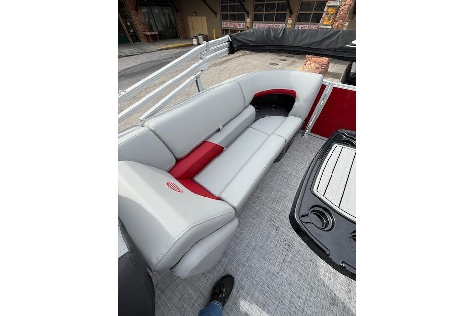 2026 Sun Tracker Party Barge 22 DLX interior with gray and red seating.