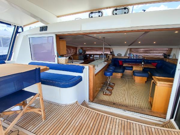 Interior of 2009 Catana 65 yacht with spacious seating and modern kitchen.