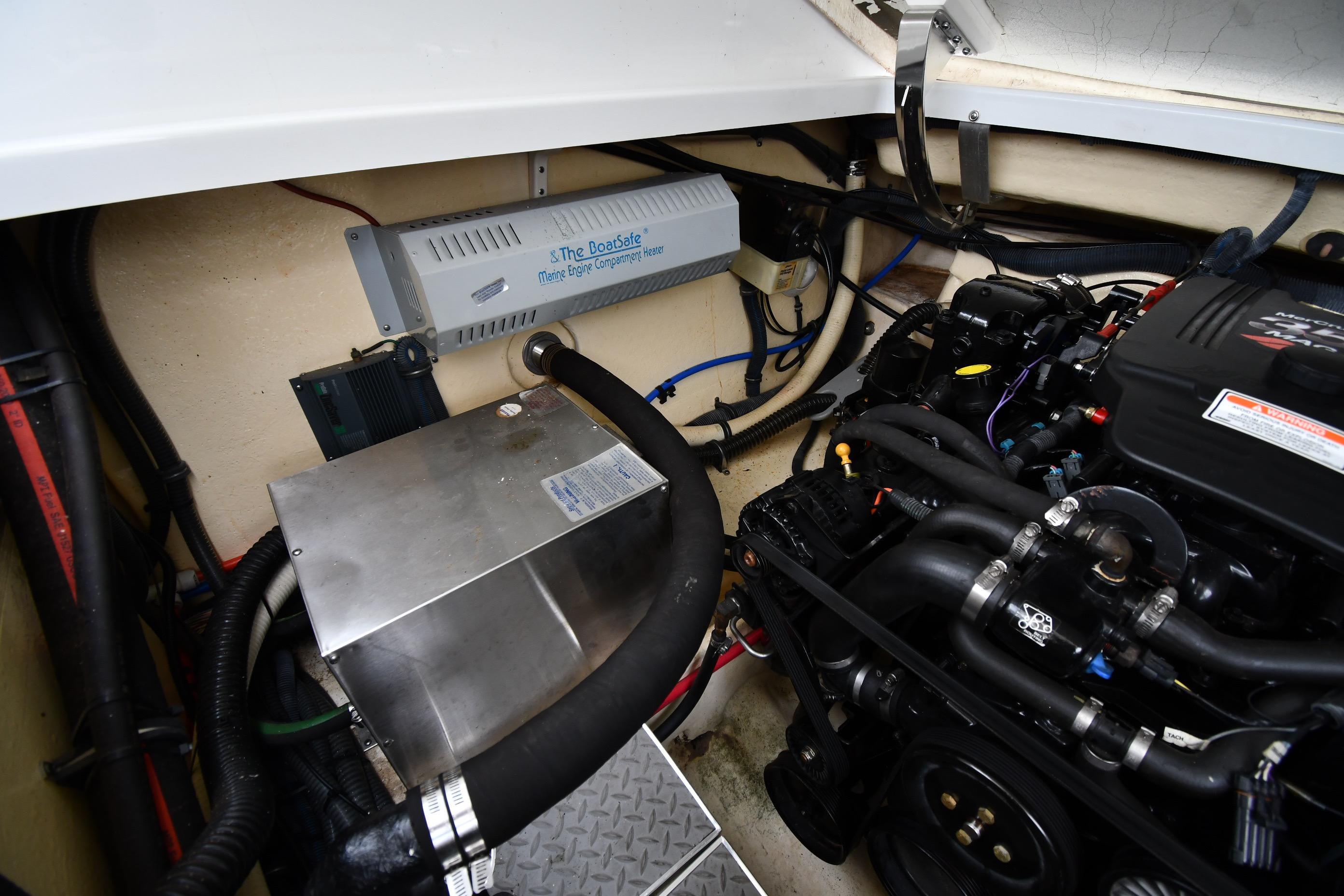 Engine compartment of a 2004 Formula 330 Sun Sport boat, showcasing mechanical components.