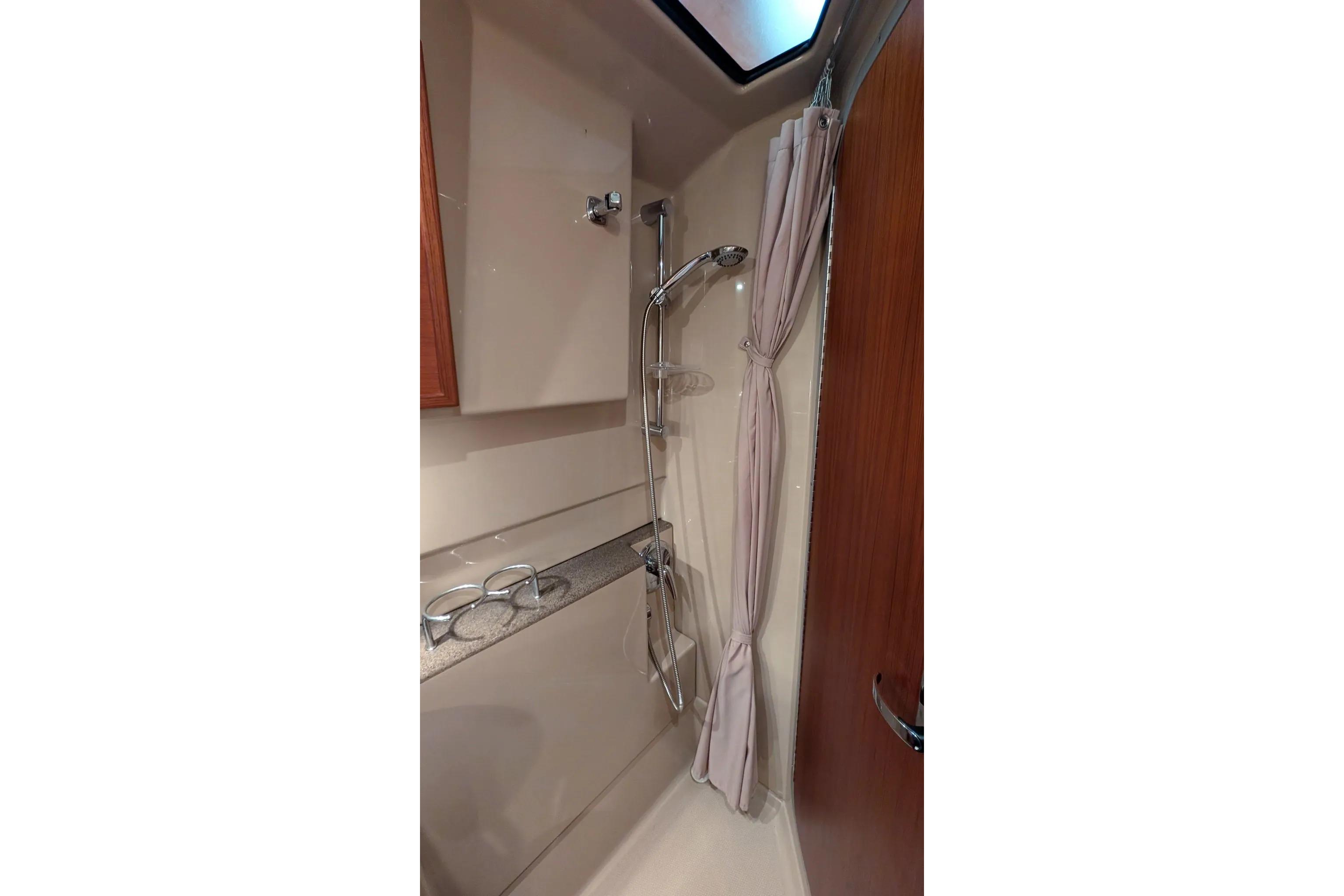 Shower area in 2015 Ranger Tugs R-29 S boat, featuring curtain and modern fixtures.