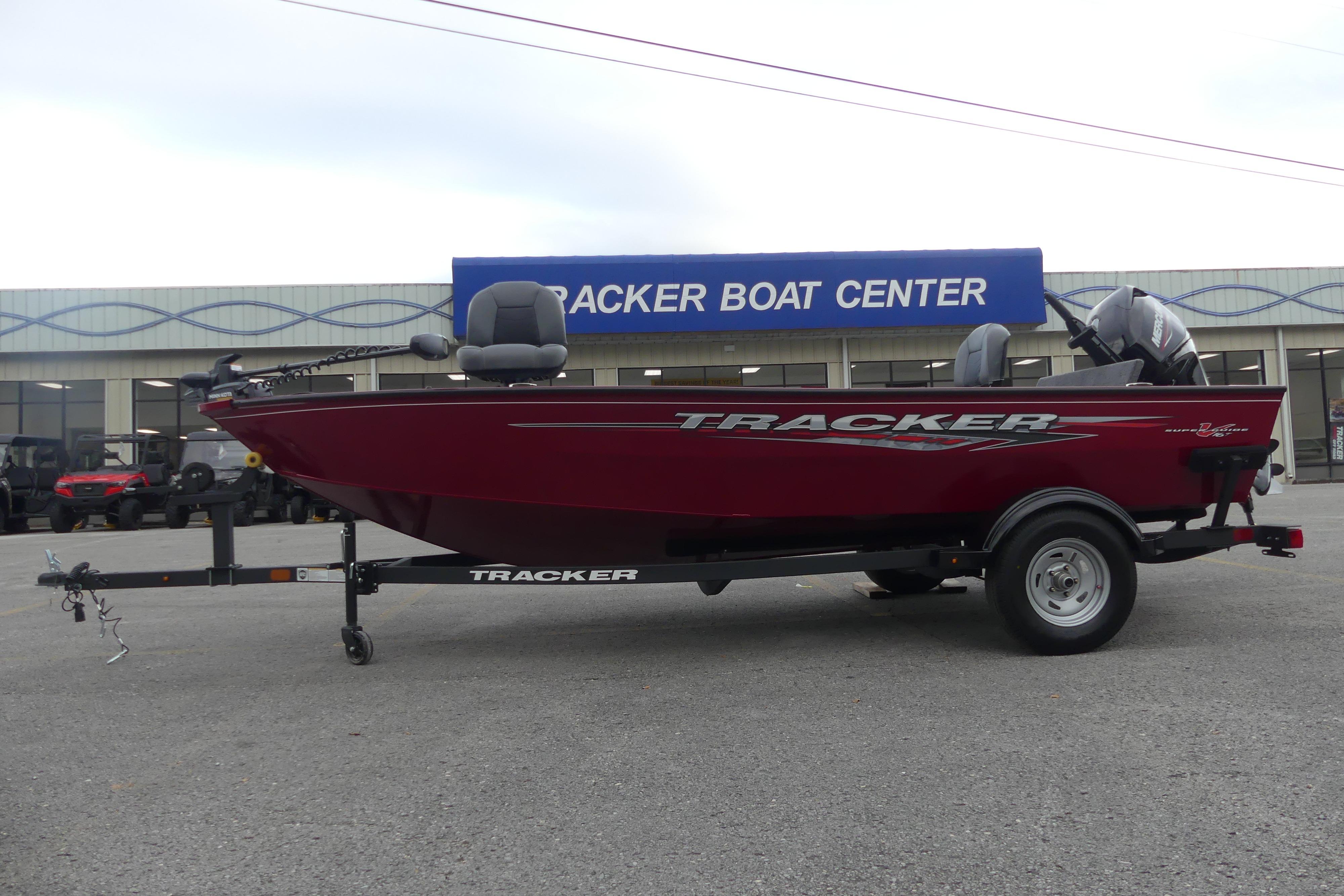 2025 Tracker Super Guide V-16 T boat at Tracker Boat Center, red exterior, on trailer.