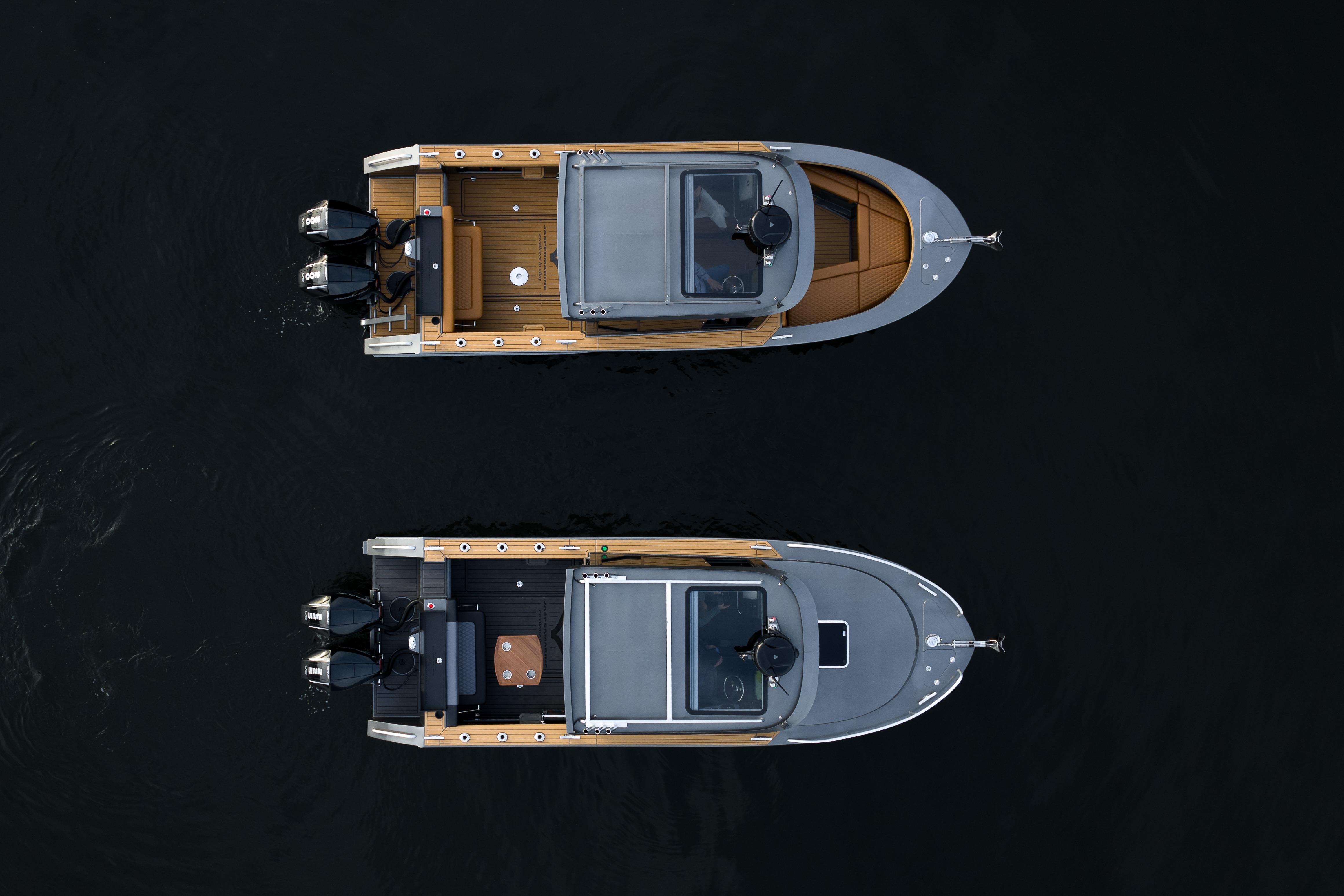 Top view of two 2026 Jasper Marine Defender 22 boats on dark water.