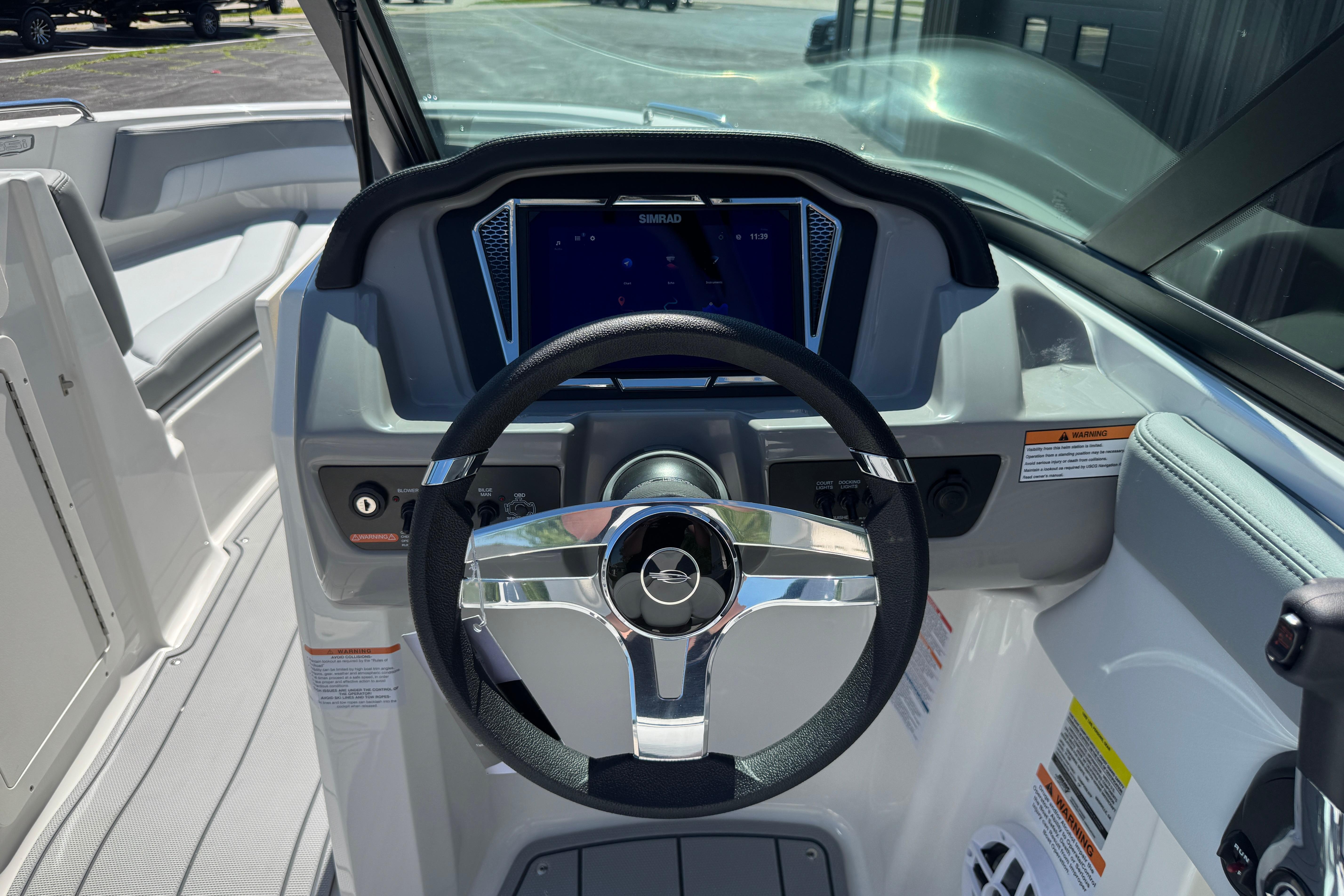2026 Chaparral 21 SSi boat dashboard with steering wheel and modern controls.