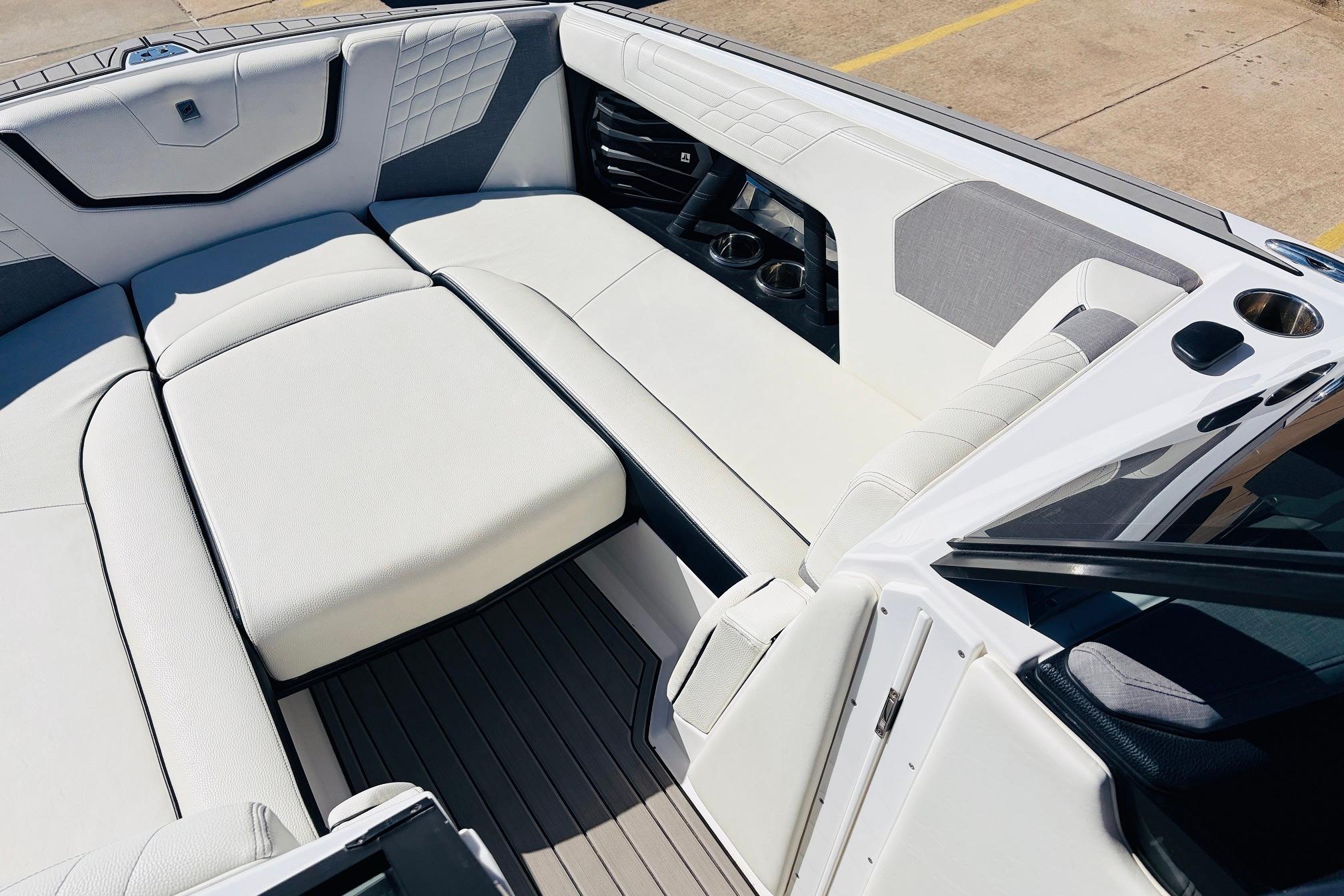 2023 Nautique Super Air Nautique G25 interior with luxurious white seating and cup holders.
