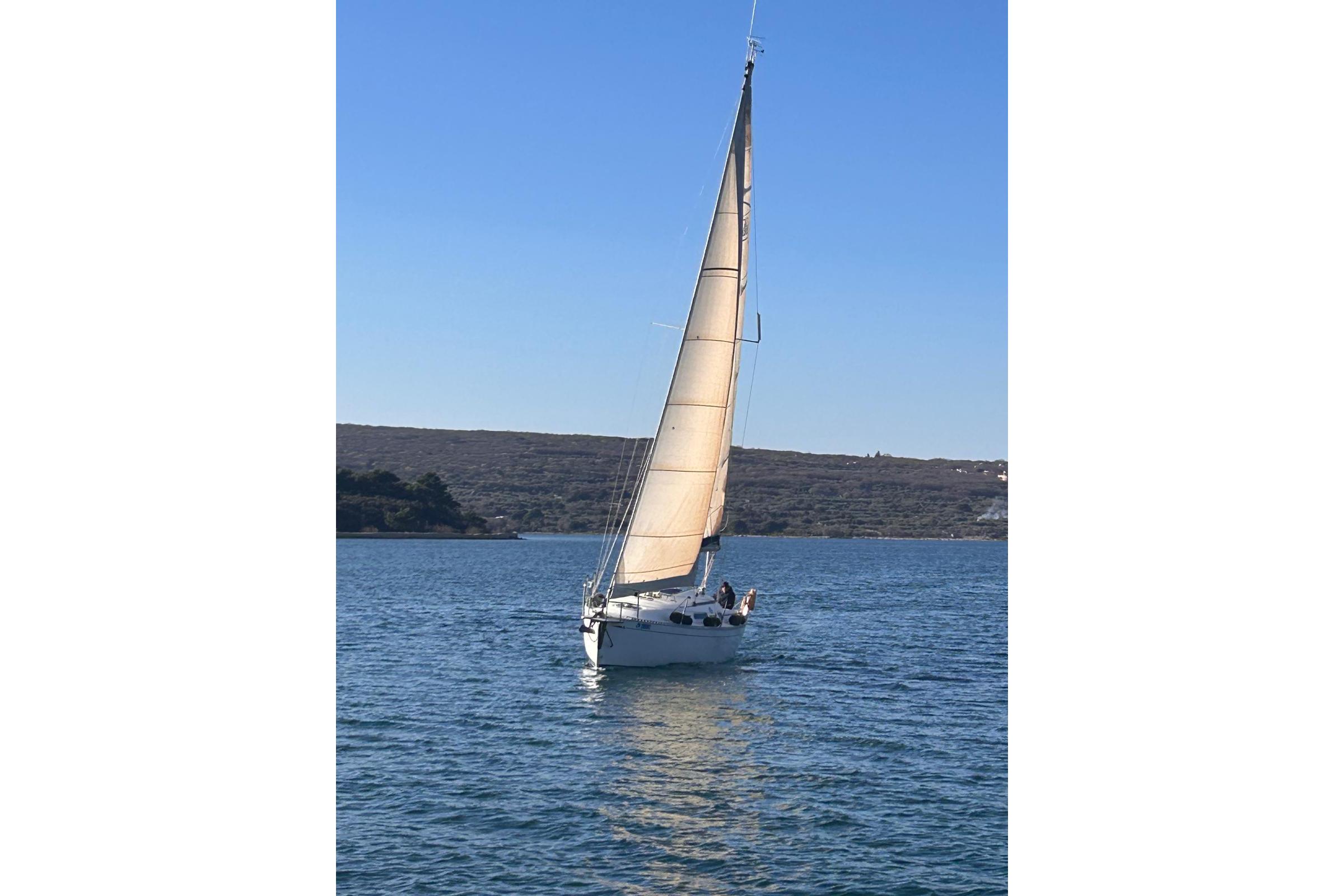 Sailing yacht Dufour 30 Classic, 2001 model, gliding on calm blue waters.
