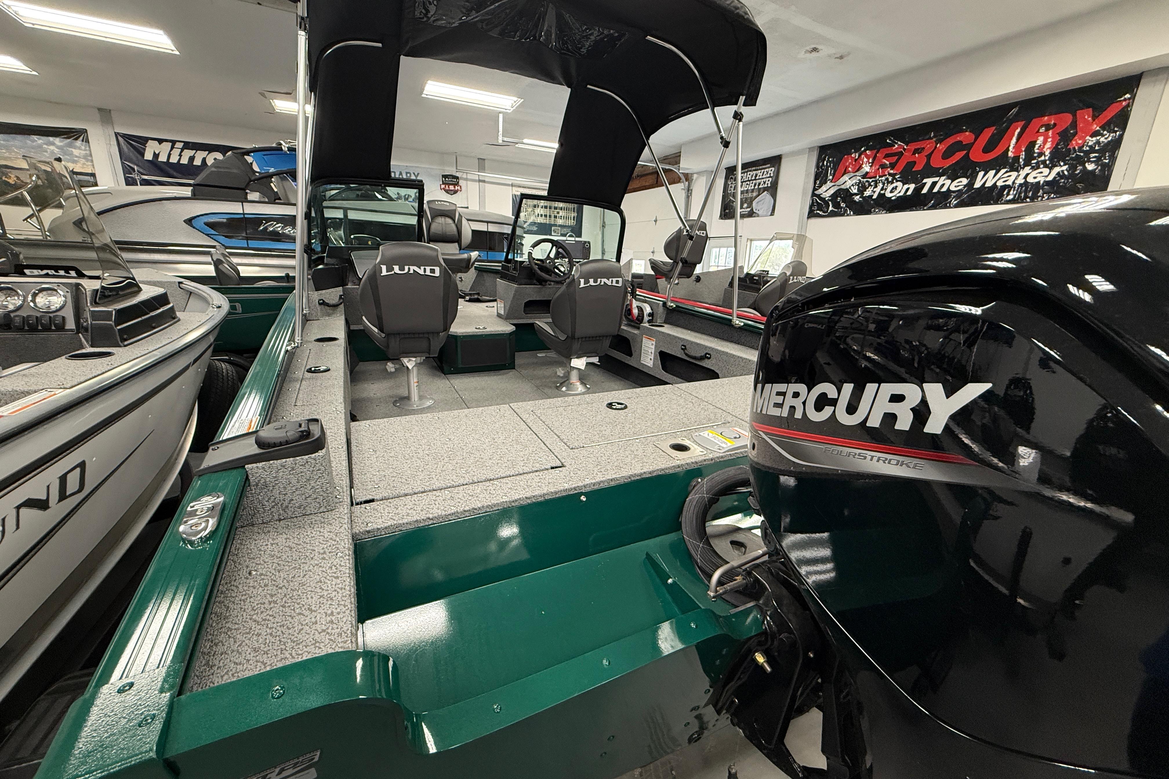 2026 Lund 1775 Adventure Sport boat with Mercury engine in showroom.