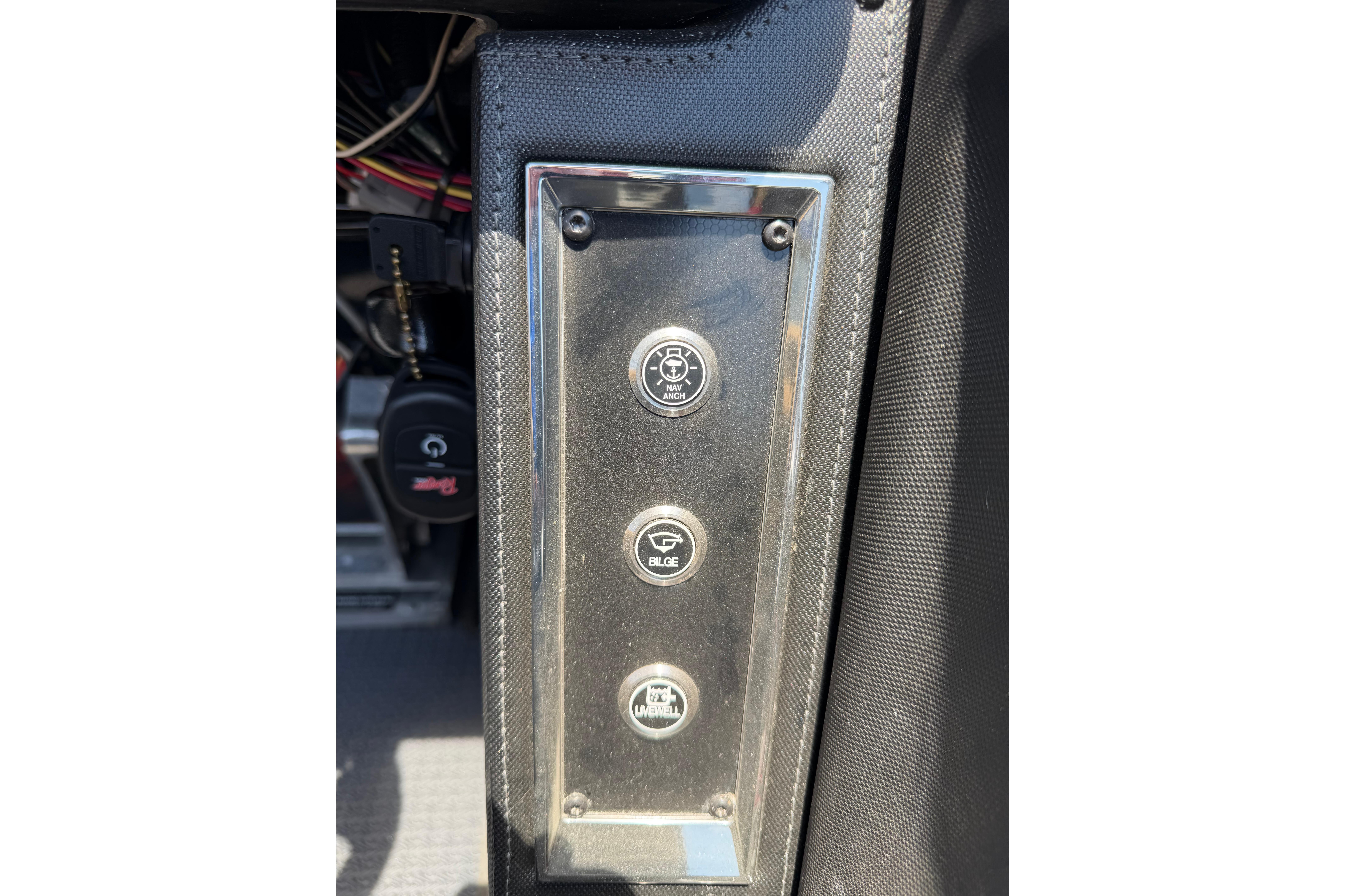 Control panel of 2023 Ranger Z520R boat with three labeled buttons.