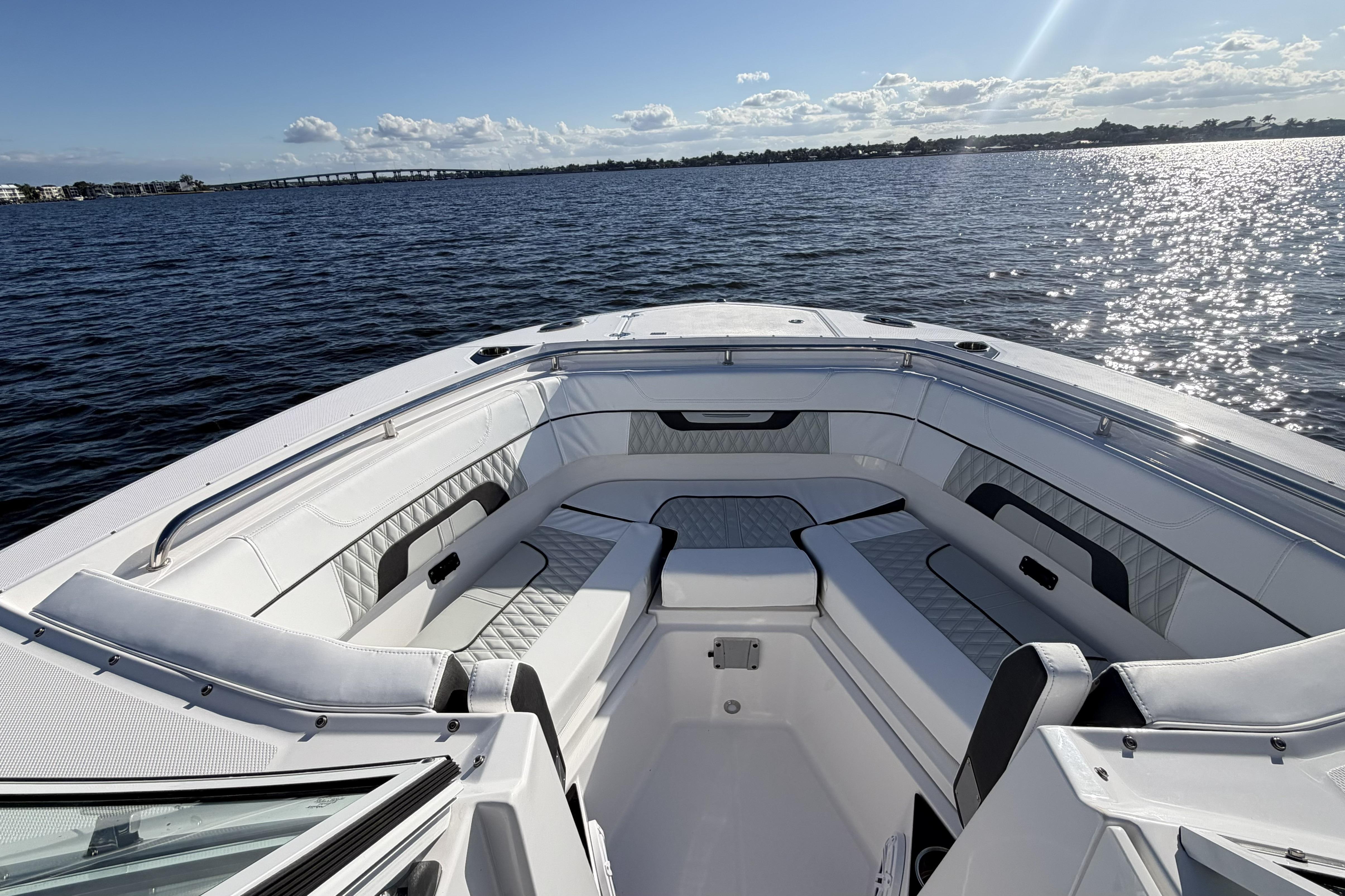2025 Blackfin 272 DC boat interior with luxurious seating on a sunny day.