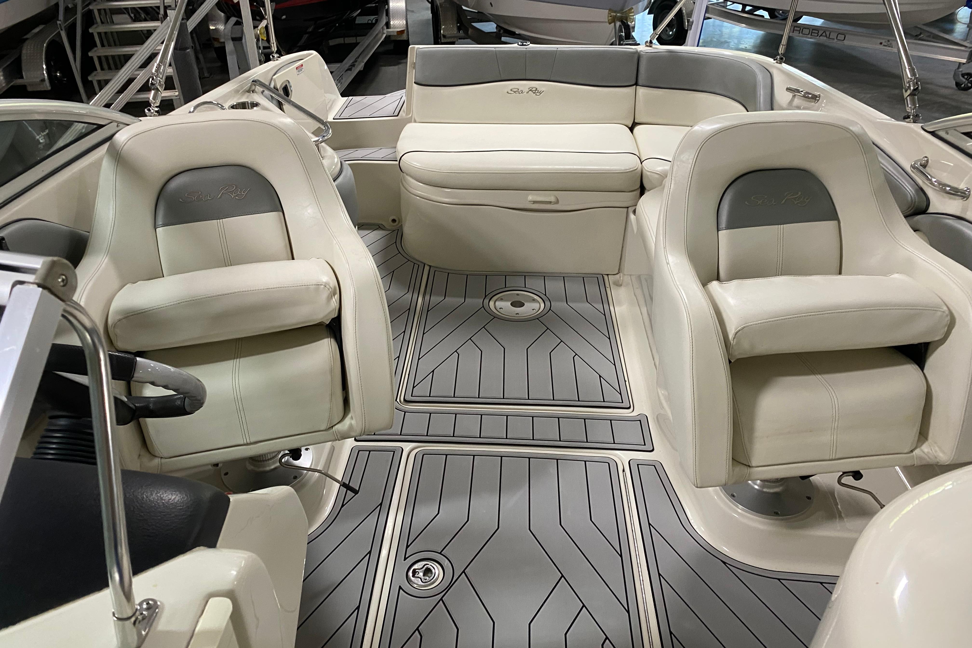 Interior of a 2008 Sea Ray 240 Sundeck boat with cushioned seating.