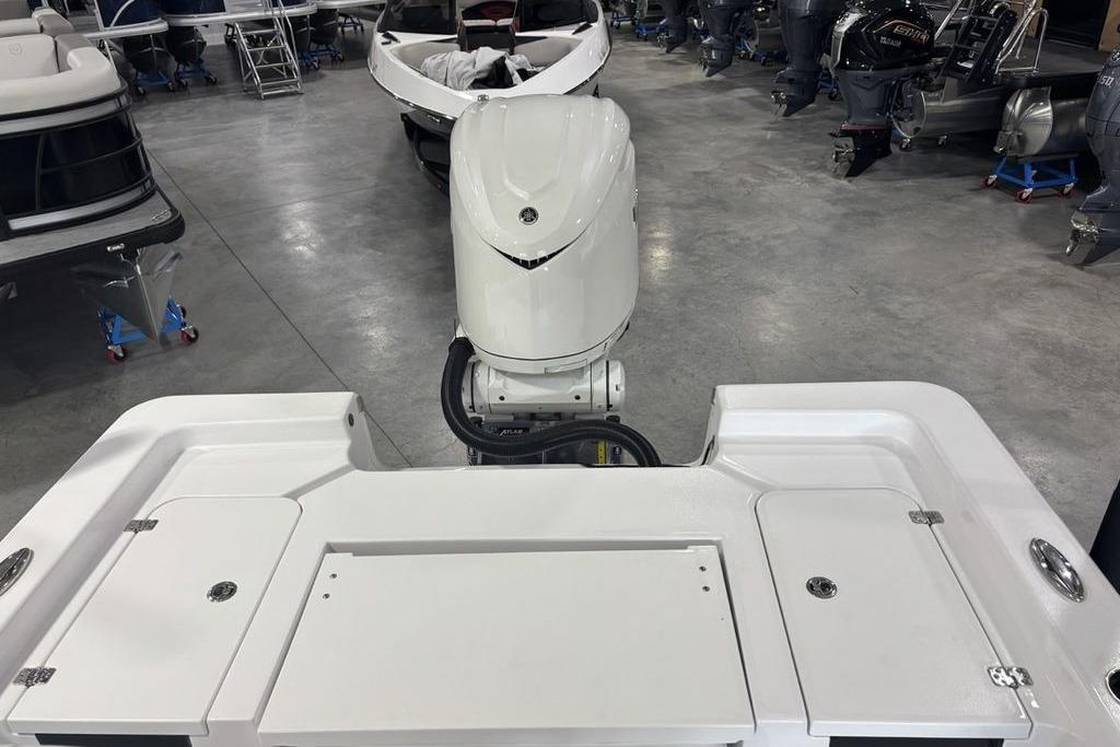 2026 Sportsman Masters 247 Bay Boat with outboard motor in showroom.