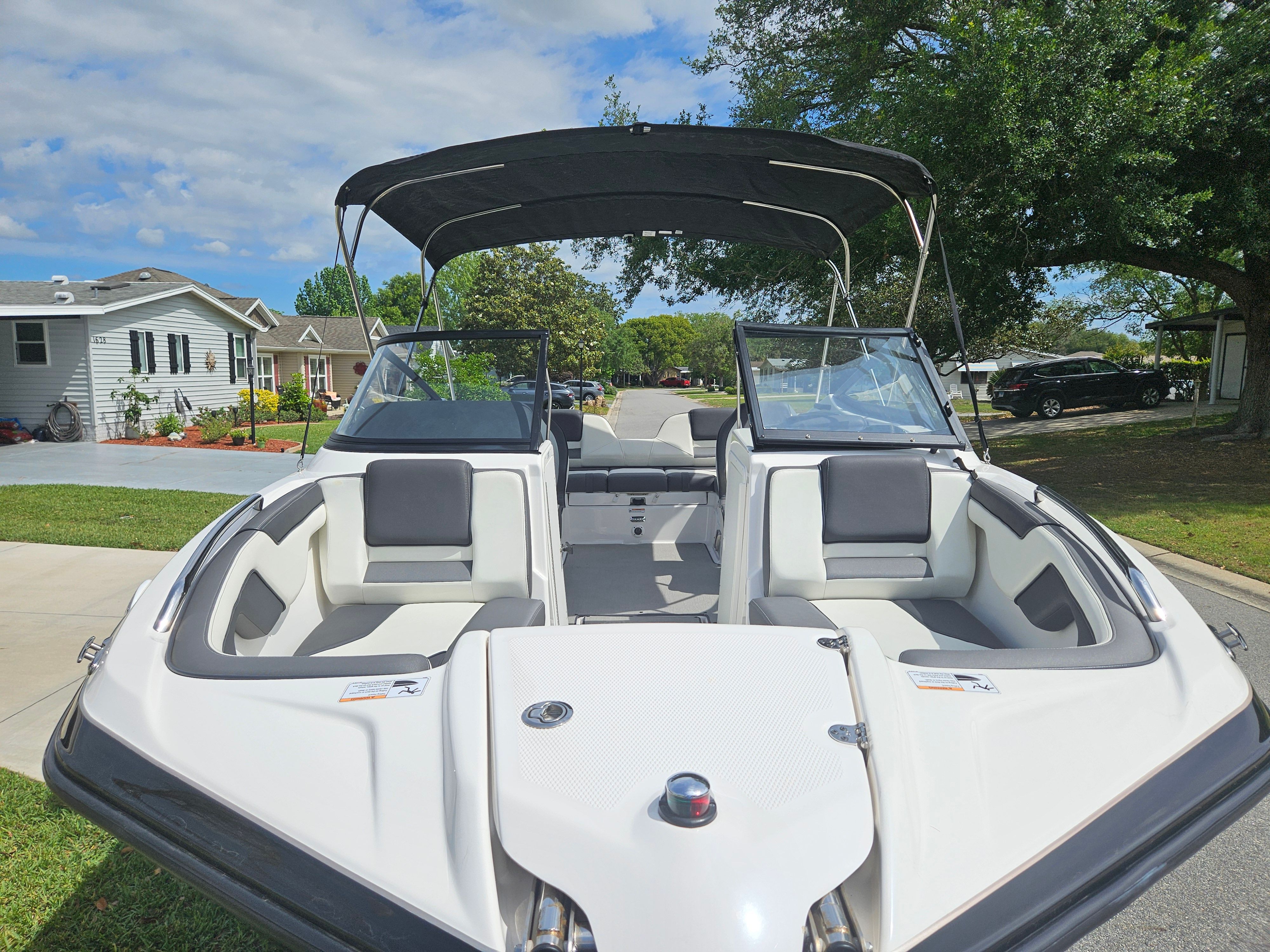 2022 Yamaha SX210 boat with open deck and sunshade.