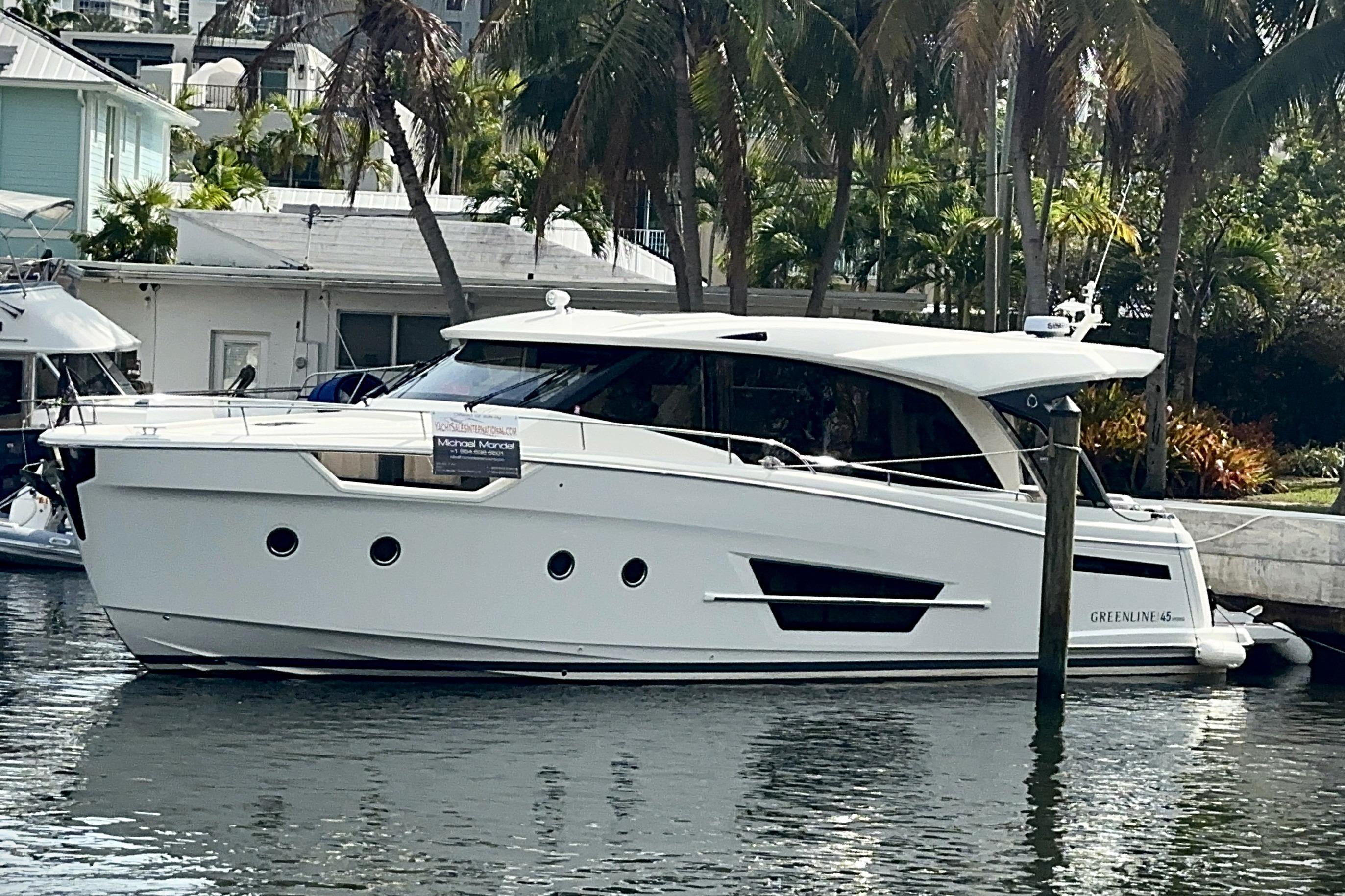 2024 Greenline 45 Coupe Hybrid yacht docked by palm trees.