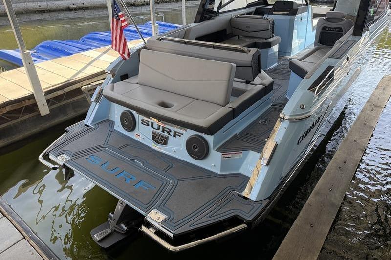 2026 Cobalt R8 Surf boat docked, featuring spacious seating and sleek design.