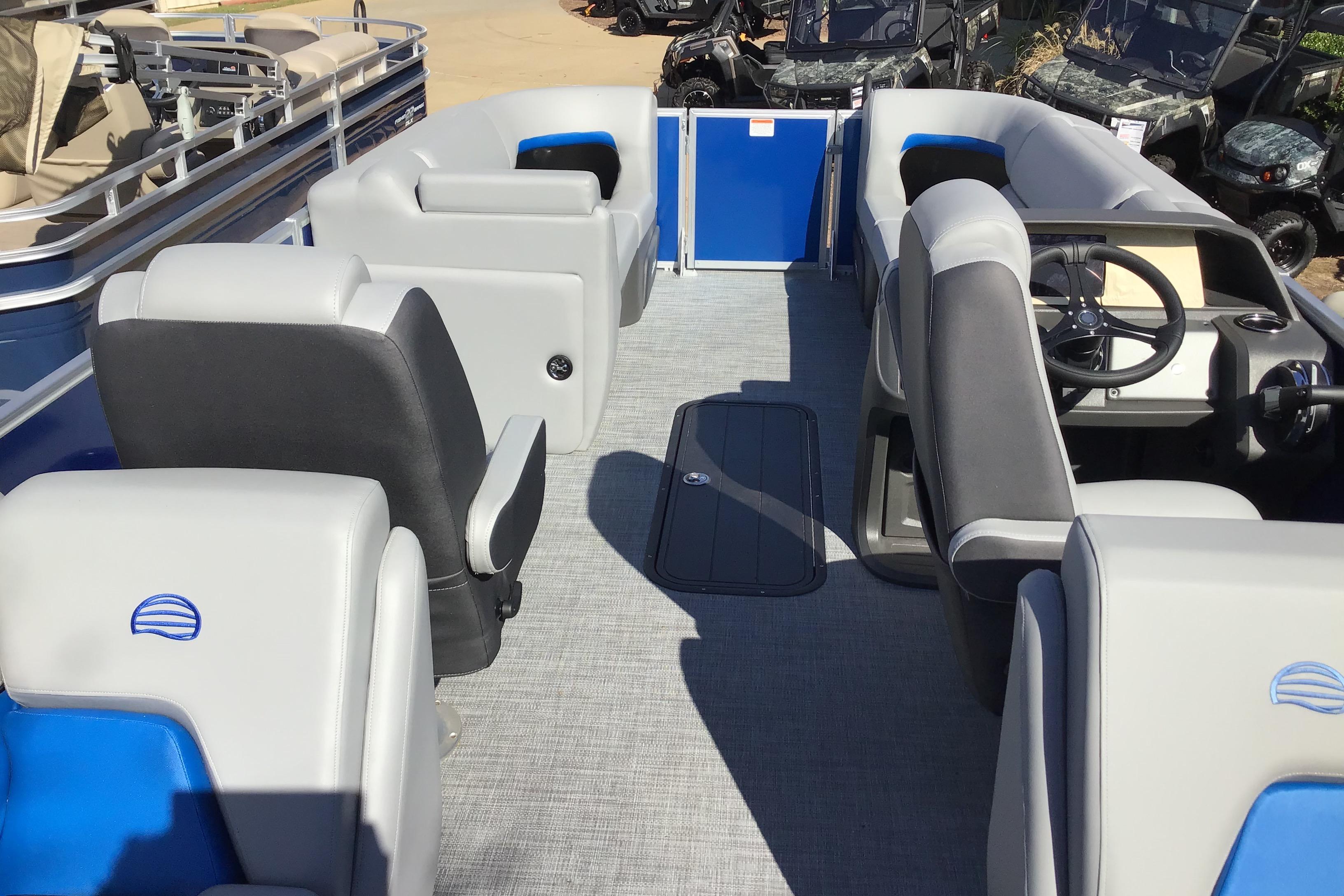 2026 Sun Tracker Party Barge 22 XP3 interior with gray seating and steering console.