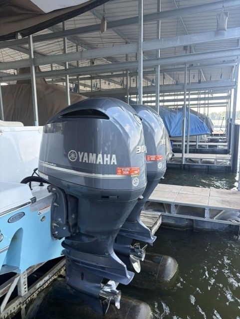 Two Yamaha outboard motors on a boat in a marina.