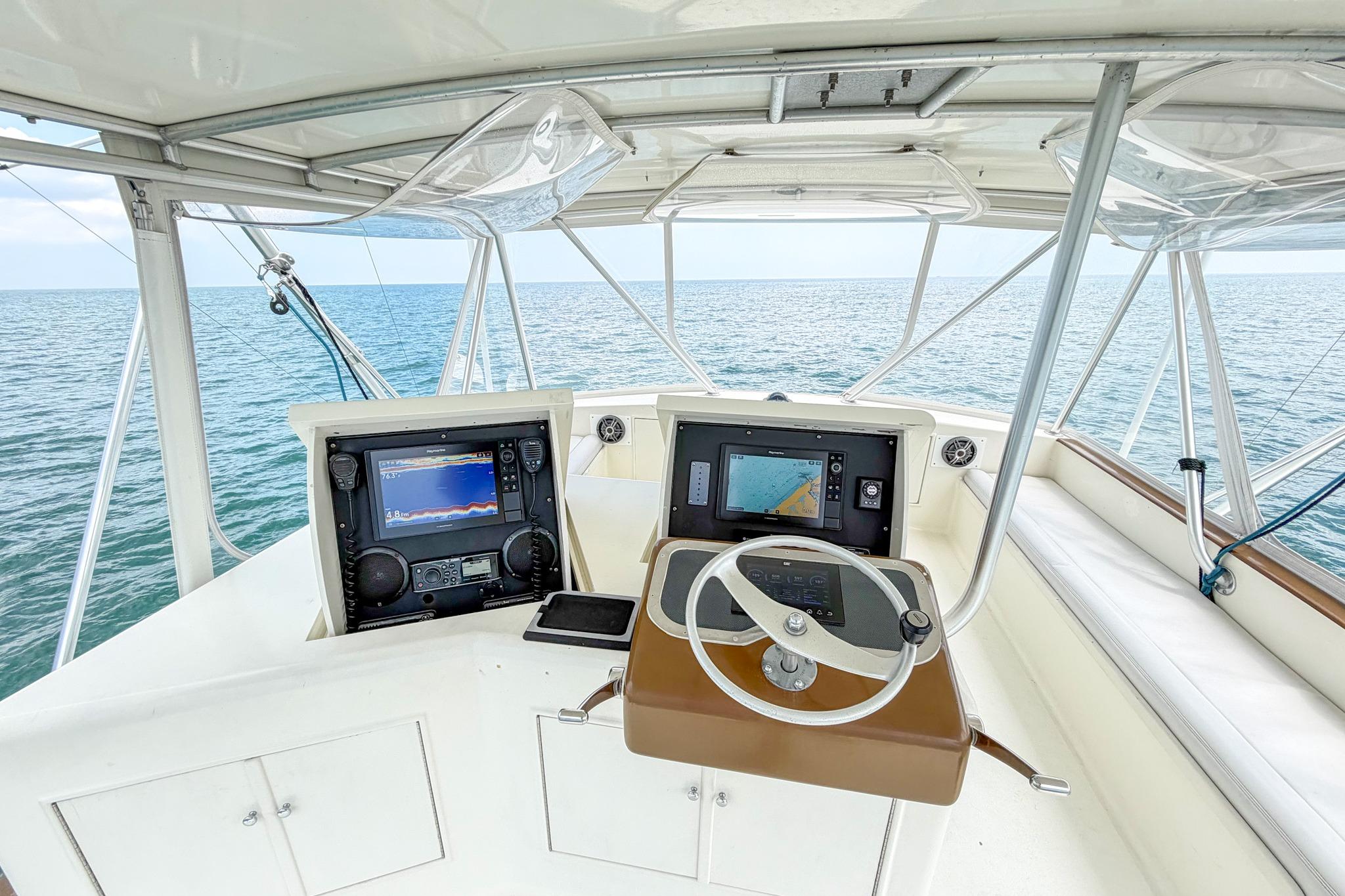Cockpit of 1998 Blackwell Custom Carolina Sportfish with navigation screens, steering wheel, and ocean view.