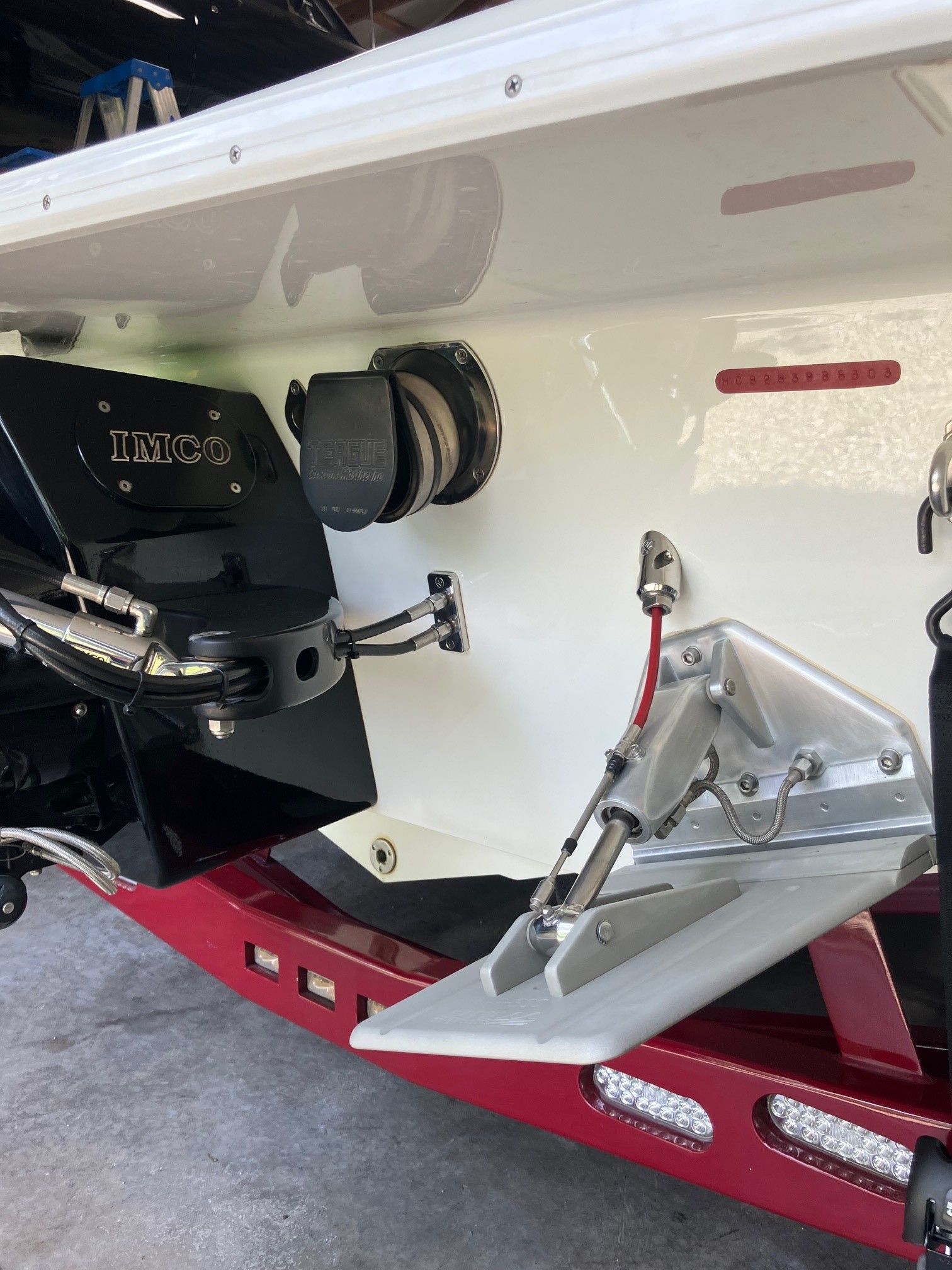 The image shows the stern of a 2003 Howard Bullet boat on a red trailer.