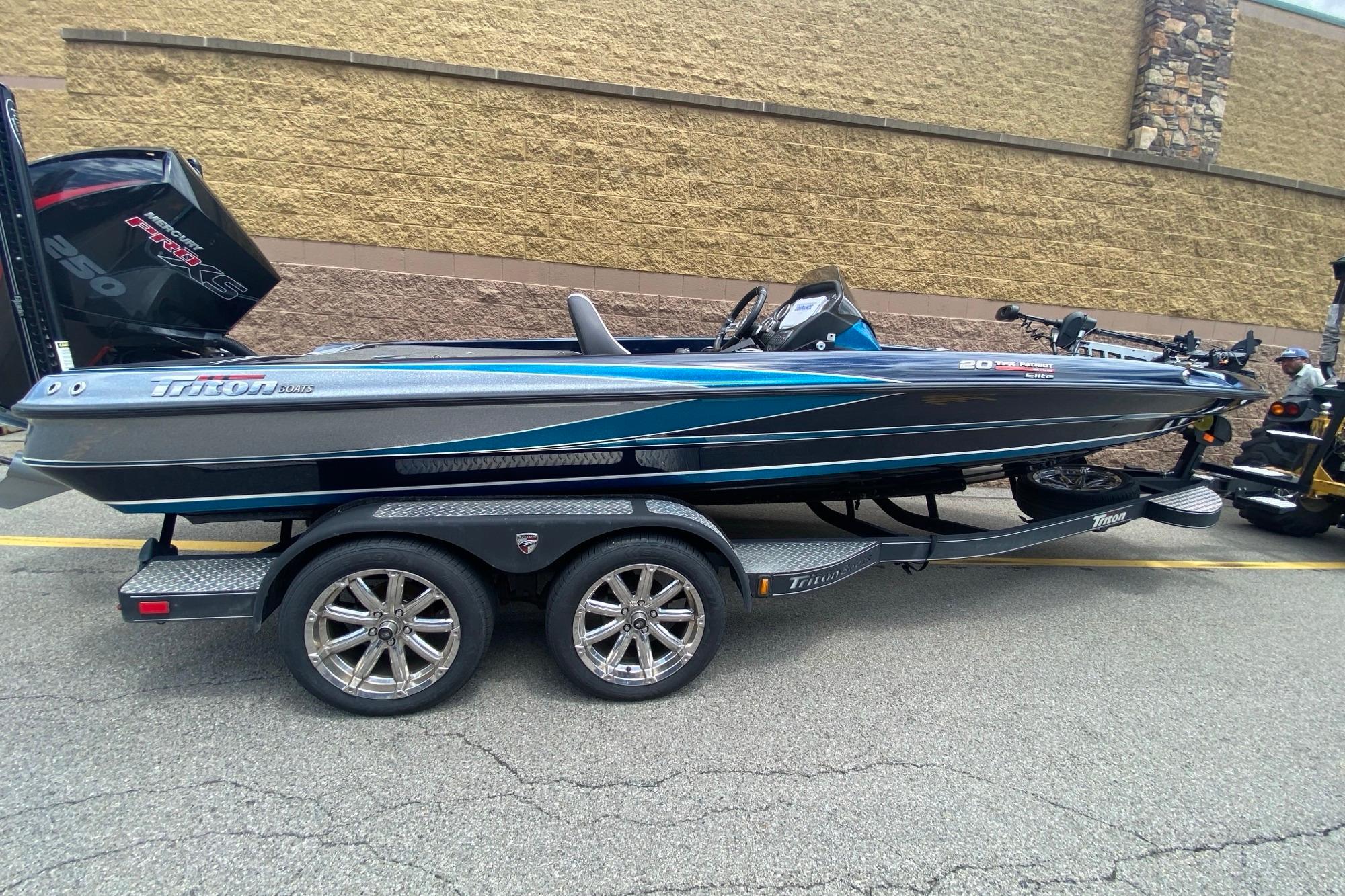 2020 Triton 20 TrX Patriot boat on trailer, sleek design with blue accents.