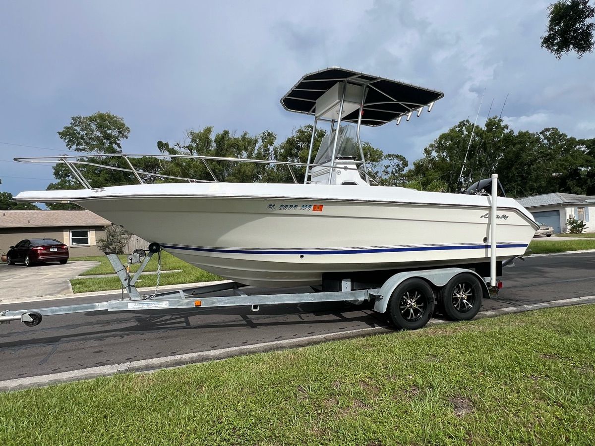 A 1994 Sea Ray Laguna boat on a trailer, parked on a street.
