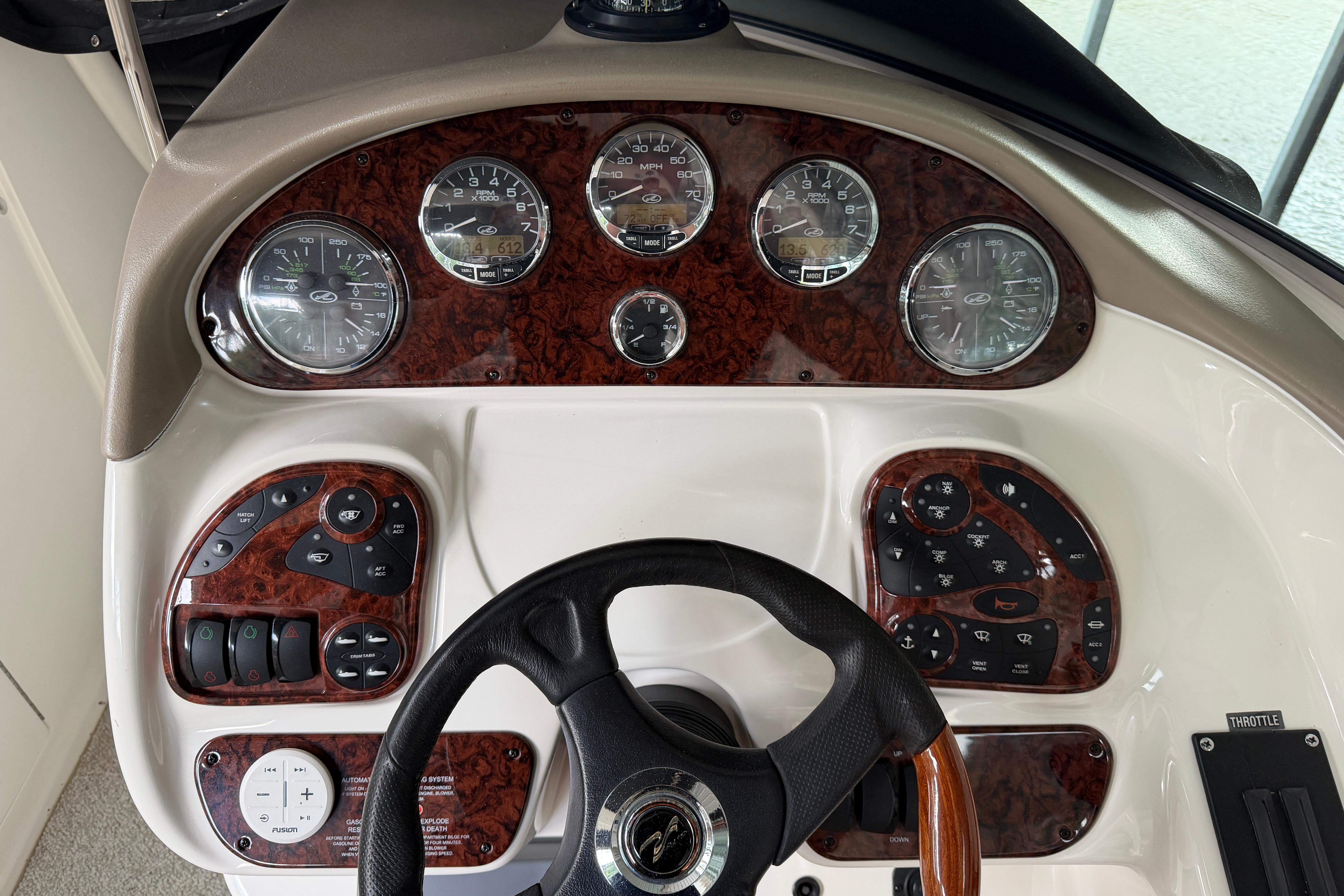Dashboard of a 2003 Sea Ray 290 Bowrider boat with gauges and controls.