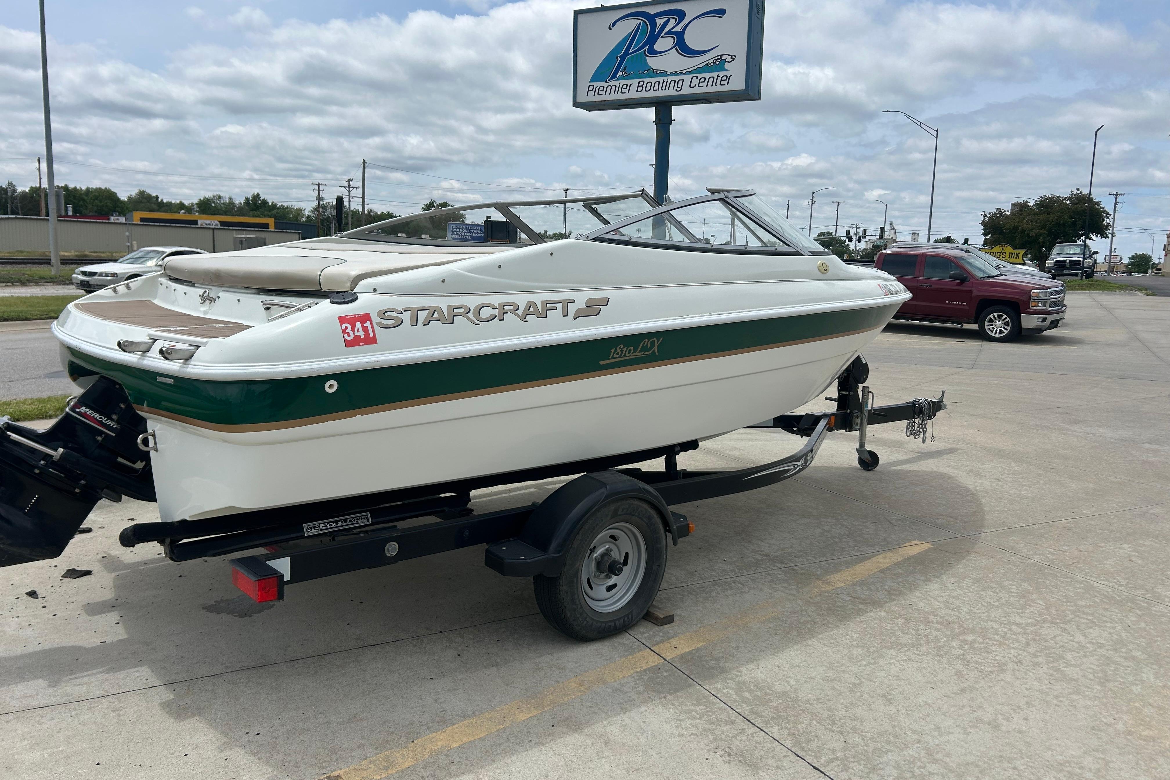 2000 Starcraft 1810 boat on trailer at Premier Boating Center parking lot.