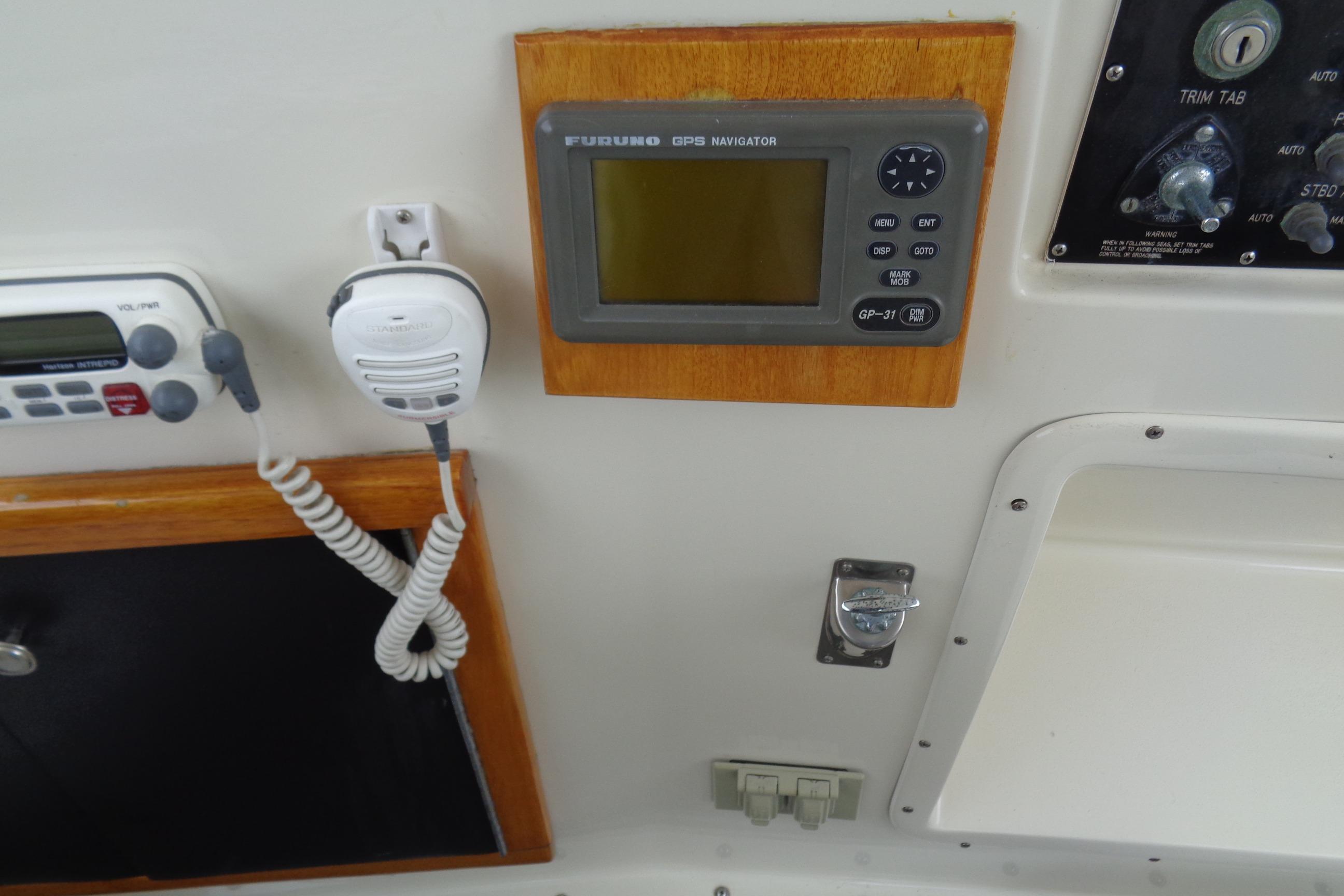 Control panel of a 1981 Hatteras 48 Cockpit Motor Yacht with GPS and radio equipment.