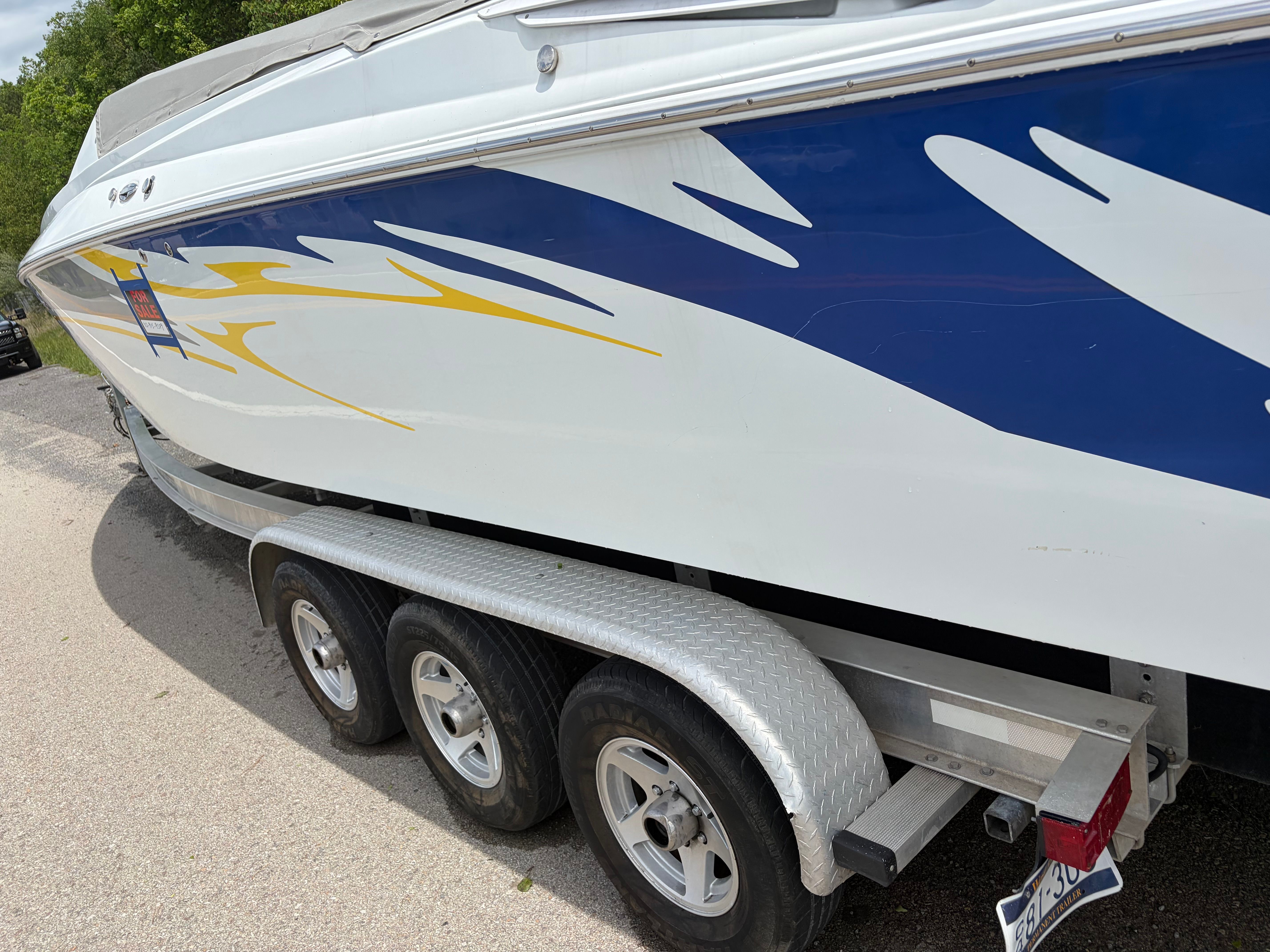 2007 Baja 30 Outlaw boat on trailer, side view.