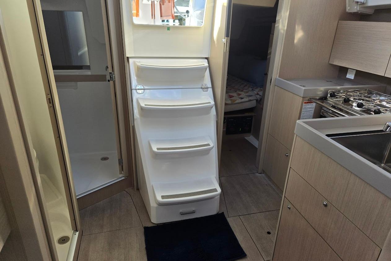 2023 Beneteau Oceanis 38.1 interior with kitchen, stairs, and cabin view.