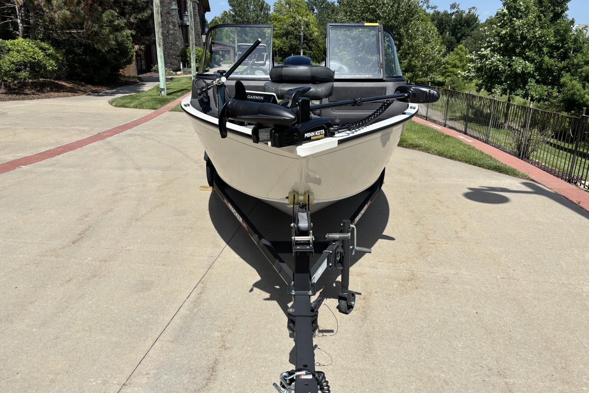 2022 Tracker Pro Guide V-16 SC boat on trailer, parked outdoors.