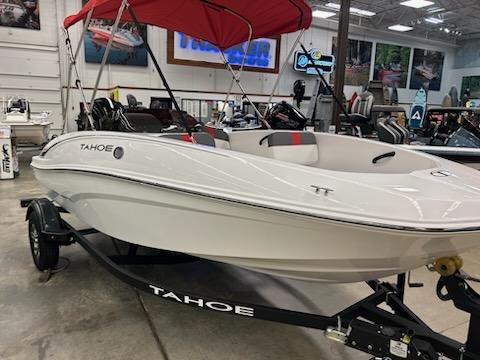 2025 Tahoe T16 boat with red canopy in showroom, displayed on trailer.