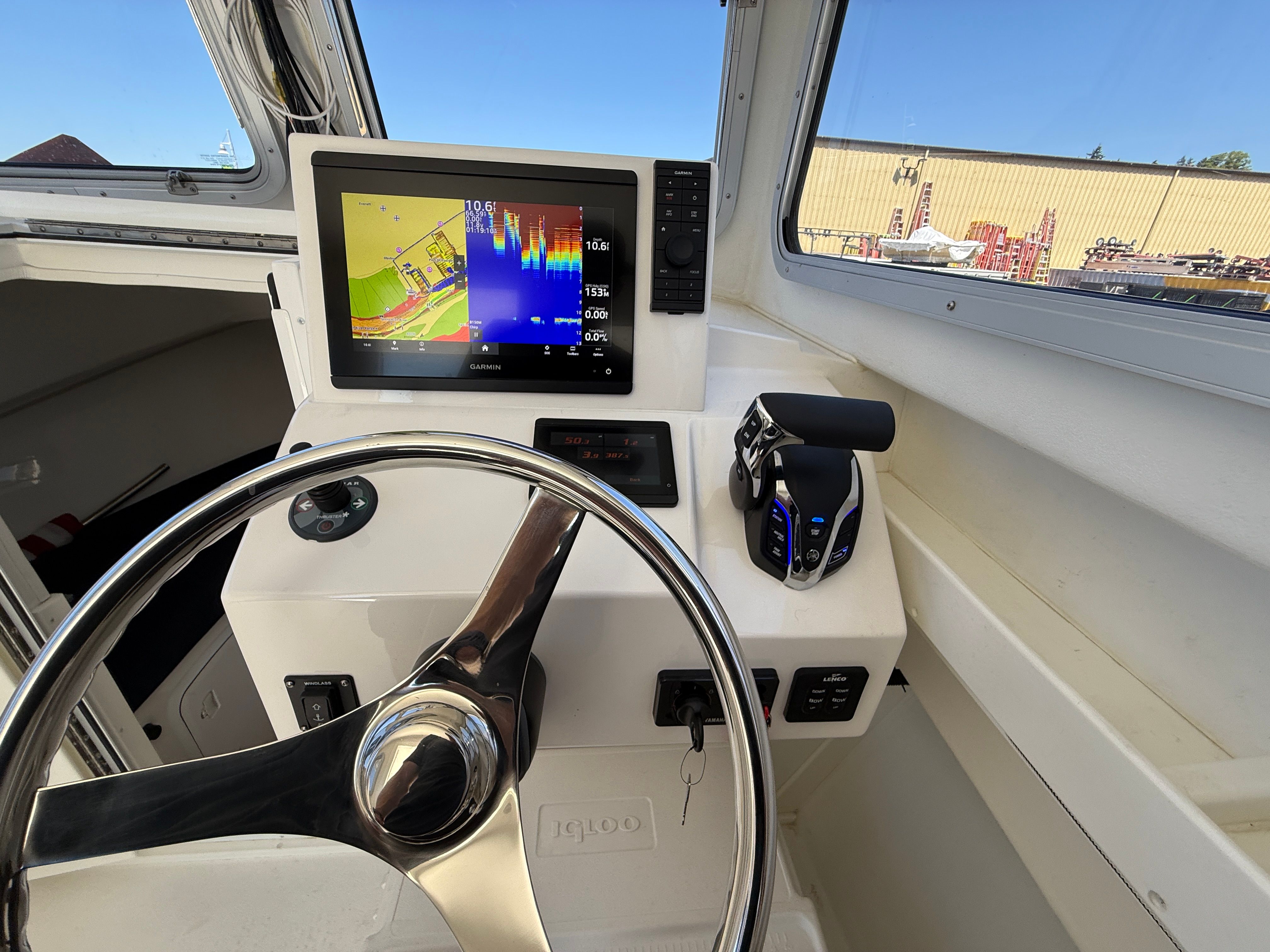 The image shows the helm of a 2015 Steiger Craft 255 Chesapeake with a modern navigation system.