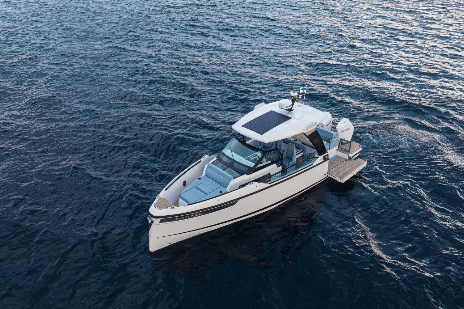 A modern motorboat with sleek design cruising on calm waters.