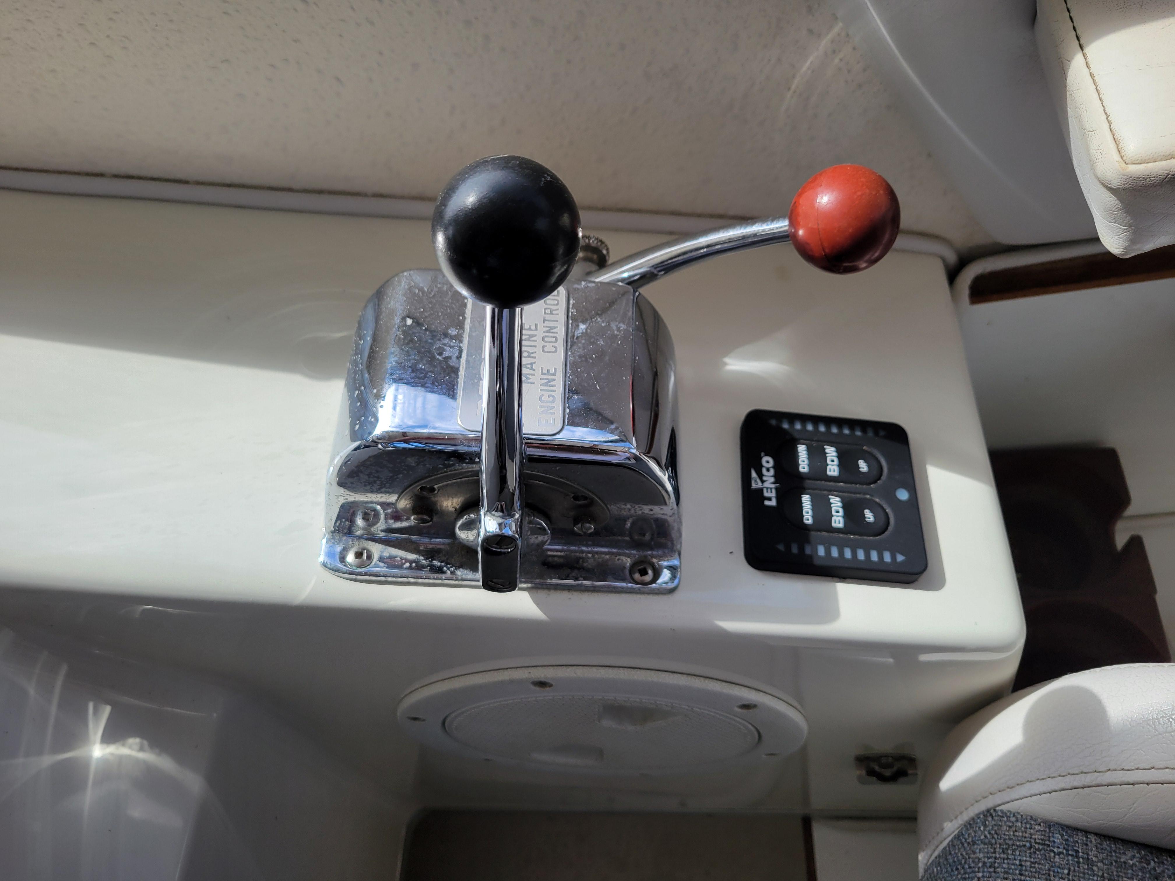 1999 SeaSport 2400 XL Limited engine control lever and Lenco trim tab switch.